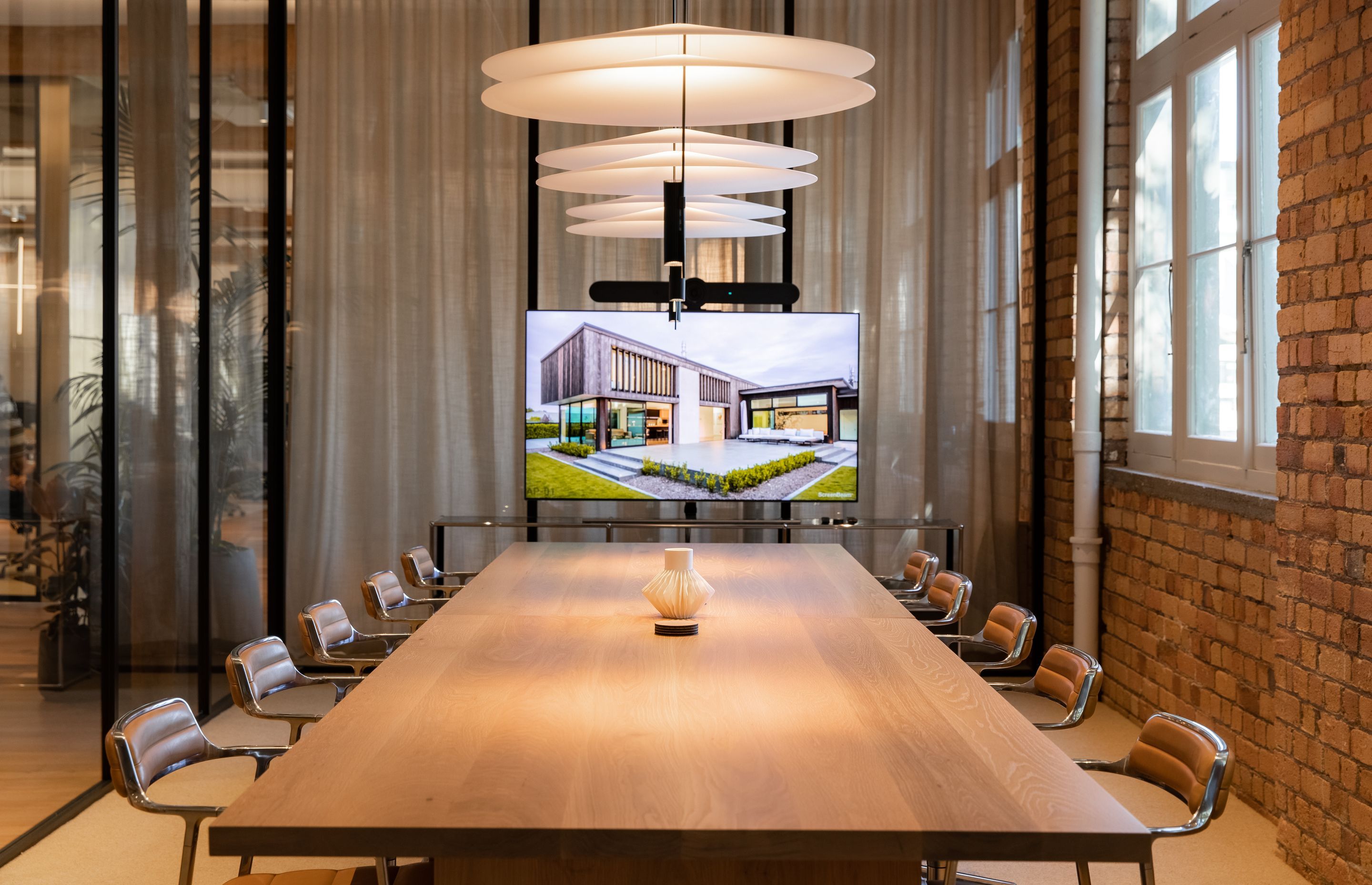 The boardroom, separated from the adjacent lounge by glass partitioning and a full drop sheer curtain. | Photographers: Oliver Compton &amp; Millie Cossou