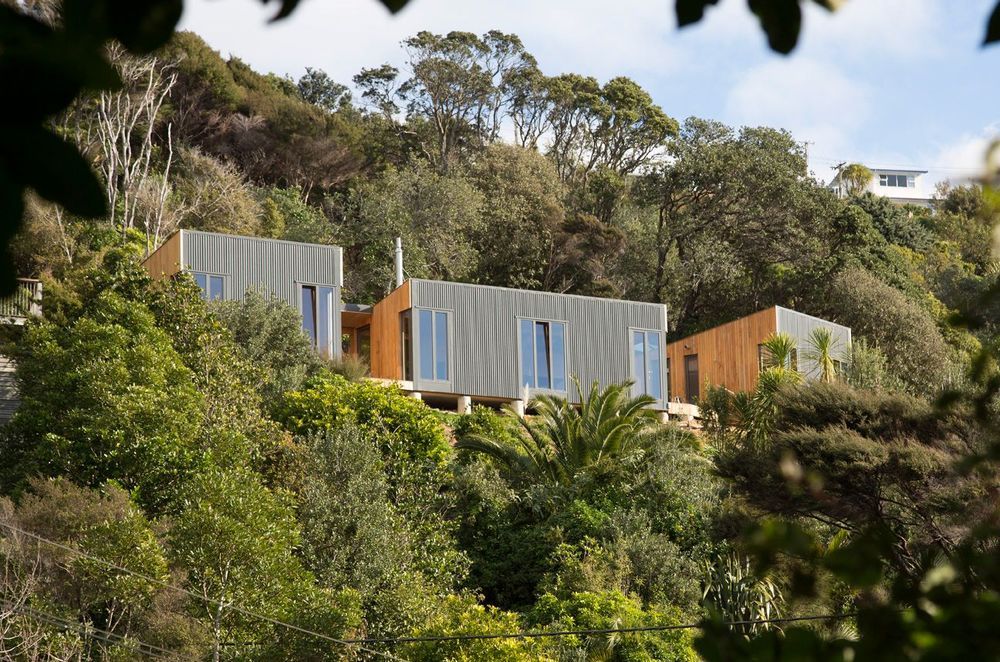 Cora House on Waiheke Island, was designed by Bonnifait + Giesen to suit a coastal environment prone to unpredictable weather with a protective facade and slim windows, connected by decks for sitting out on sunny days. Photograph by Russell Kleyn.