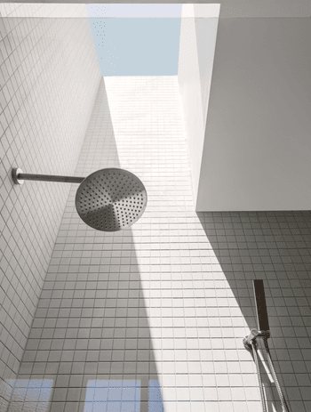 Rain shower heads disperse water evenly to simulate the feeling of rainfall for a soothing experience. Featured project: Brighton East Residence