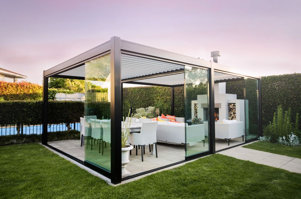 Juralco can design and manufacture your custom outdoor area with glass sliding doors and a louvred roof.