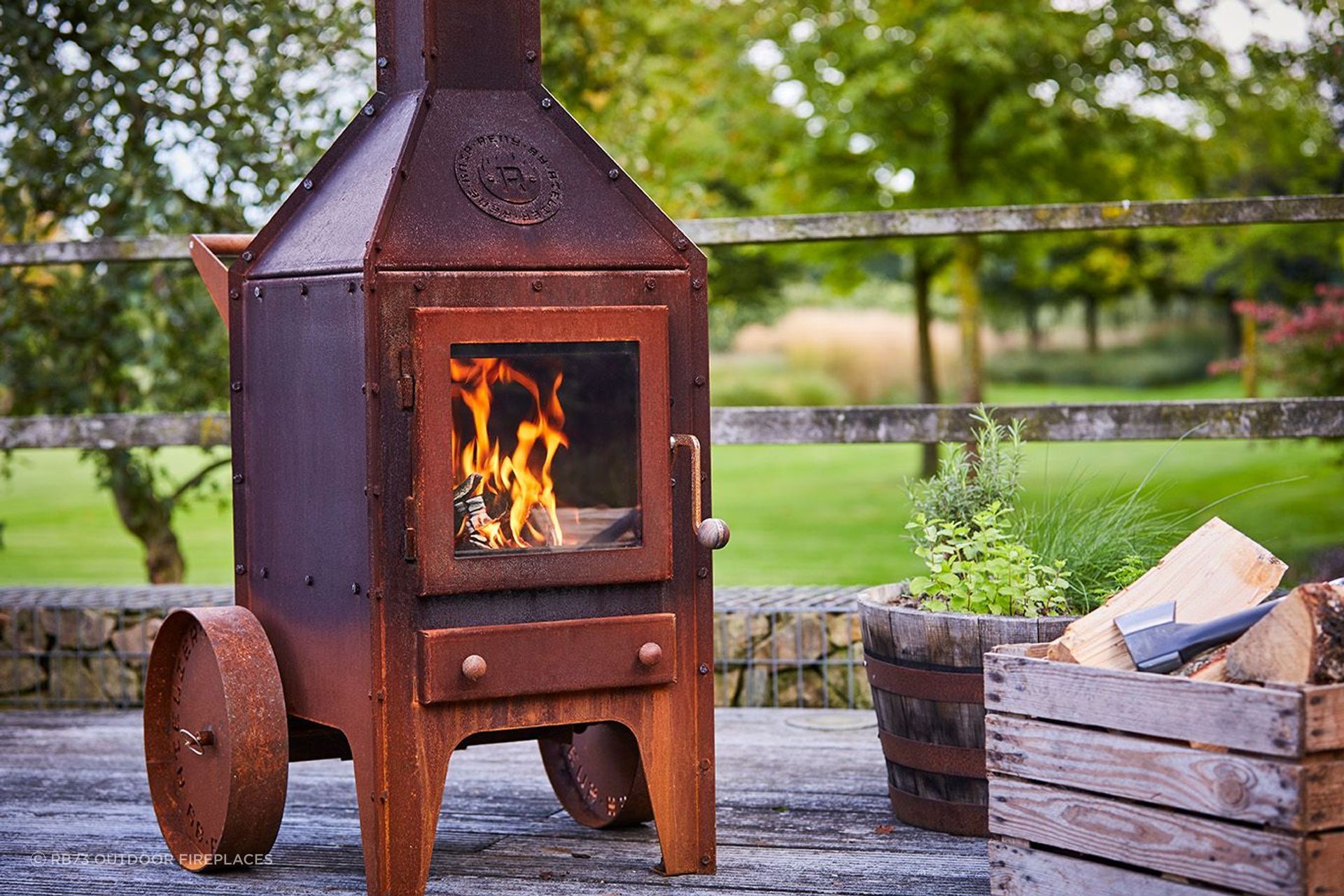 The RB73 Bijuga with wheels By Heat &amp; Grill offers rustic aesthetics and warmth.