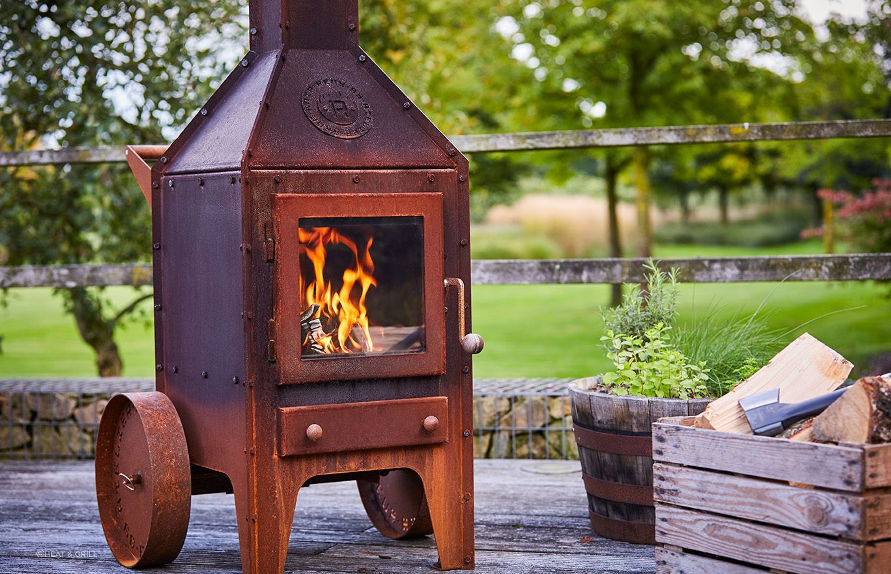 The RB73 Bijuga with wheels By Heat & Grill offers rustic aesthetics and warmth.