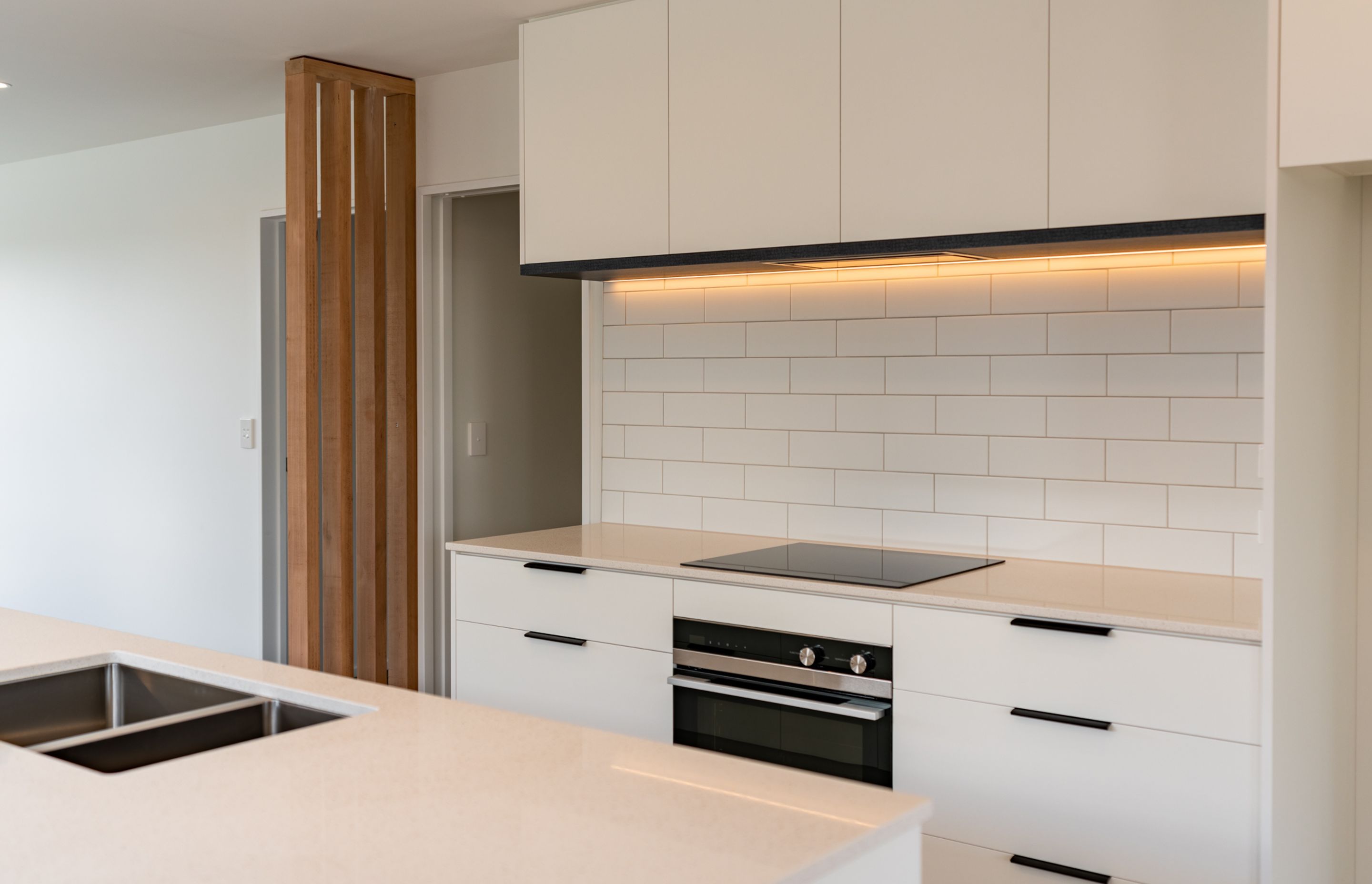This contemporary kitchen features Fisher &amp; Paykel appliances and a subway tile splashback, designed by Modern Age Kitchens &amp; Joinery.