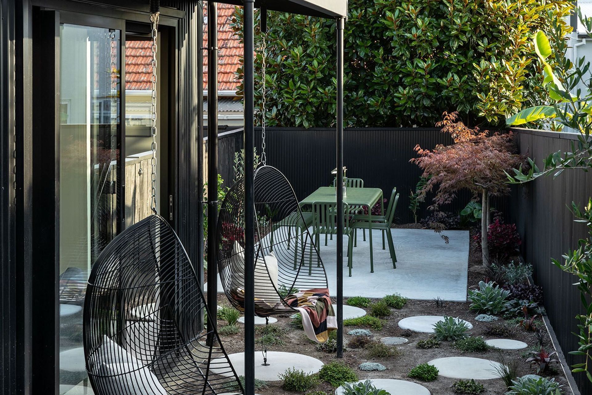 A courtyard garden that's not a courtyard garden by treating the fence like a wall of the house.