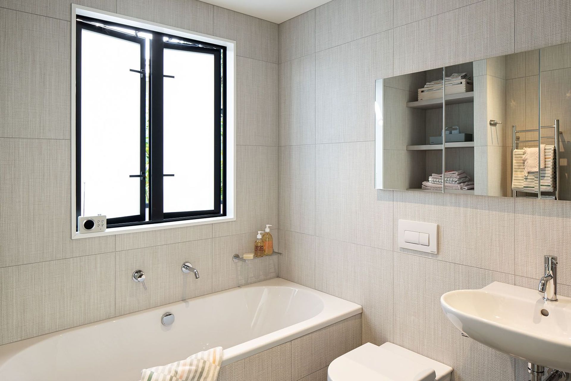 A classic bathroom features textural linen-look tiles.