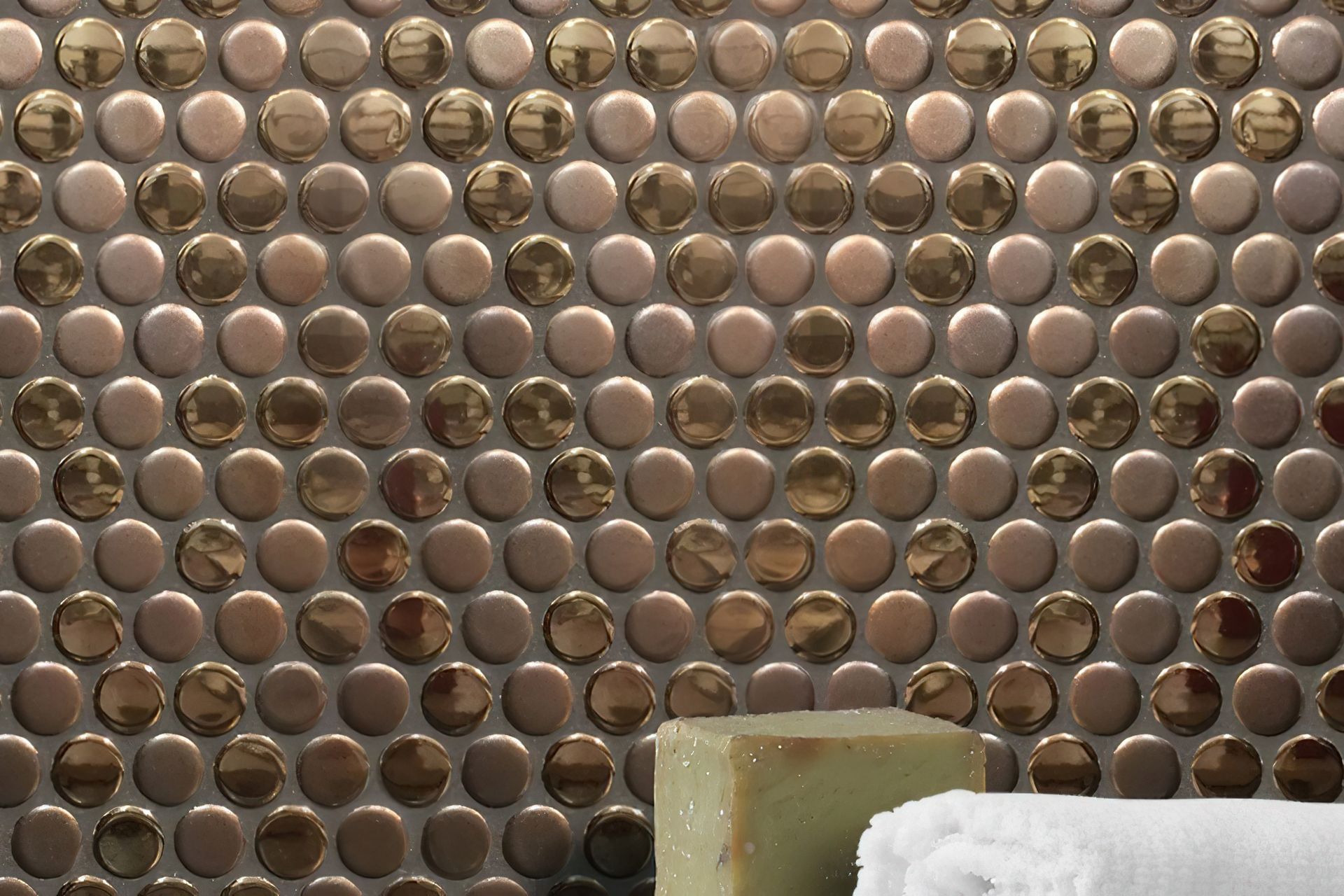 Pennyround tiles are an excellent choice for those looking to add a layer of texture in their design scheme. Our luscious Bling collection offers a rich combination of matt and glossy metallic finished pennyround tiles in your choice of copper or gold for the ultimate in luxury!