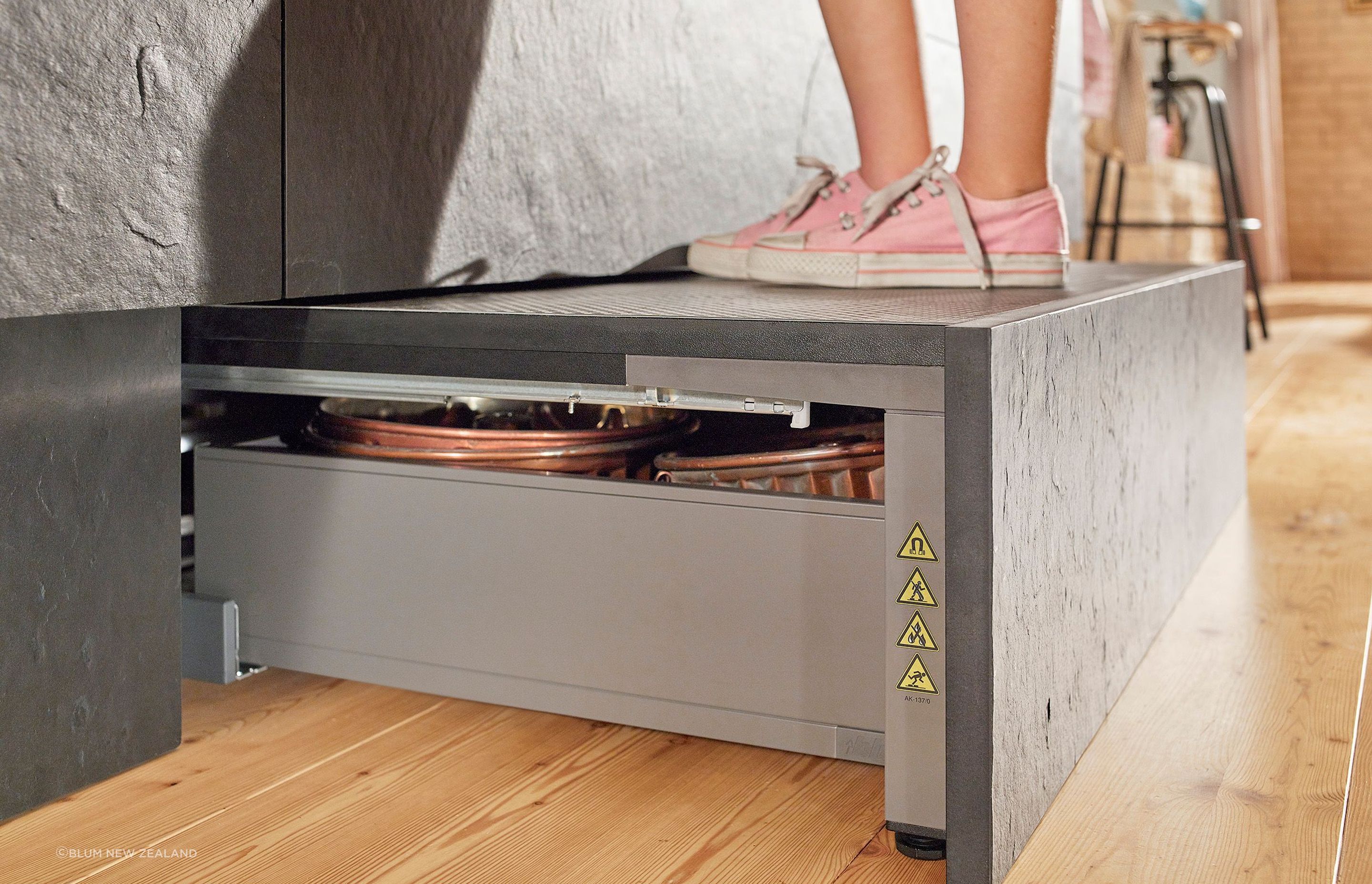 An easily accessible area for additional storage, the Space Step sits concealed behind the toe kick.