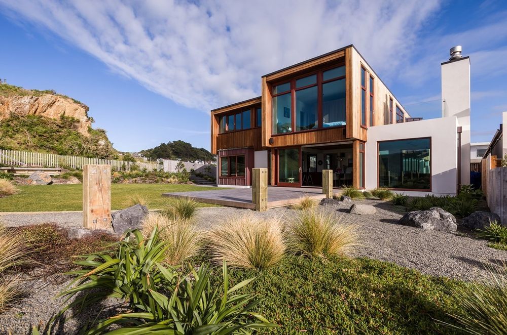 Textural materials complement the rugged landscape of this Seatoun home