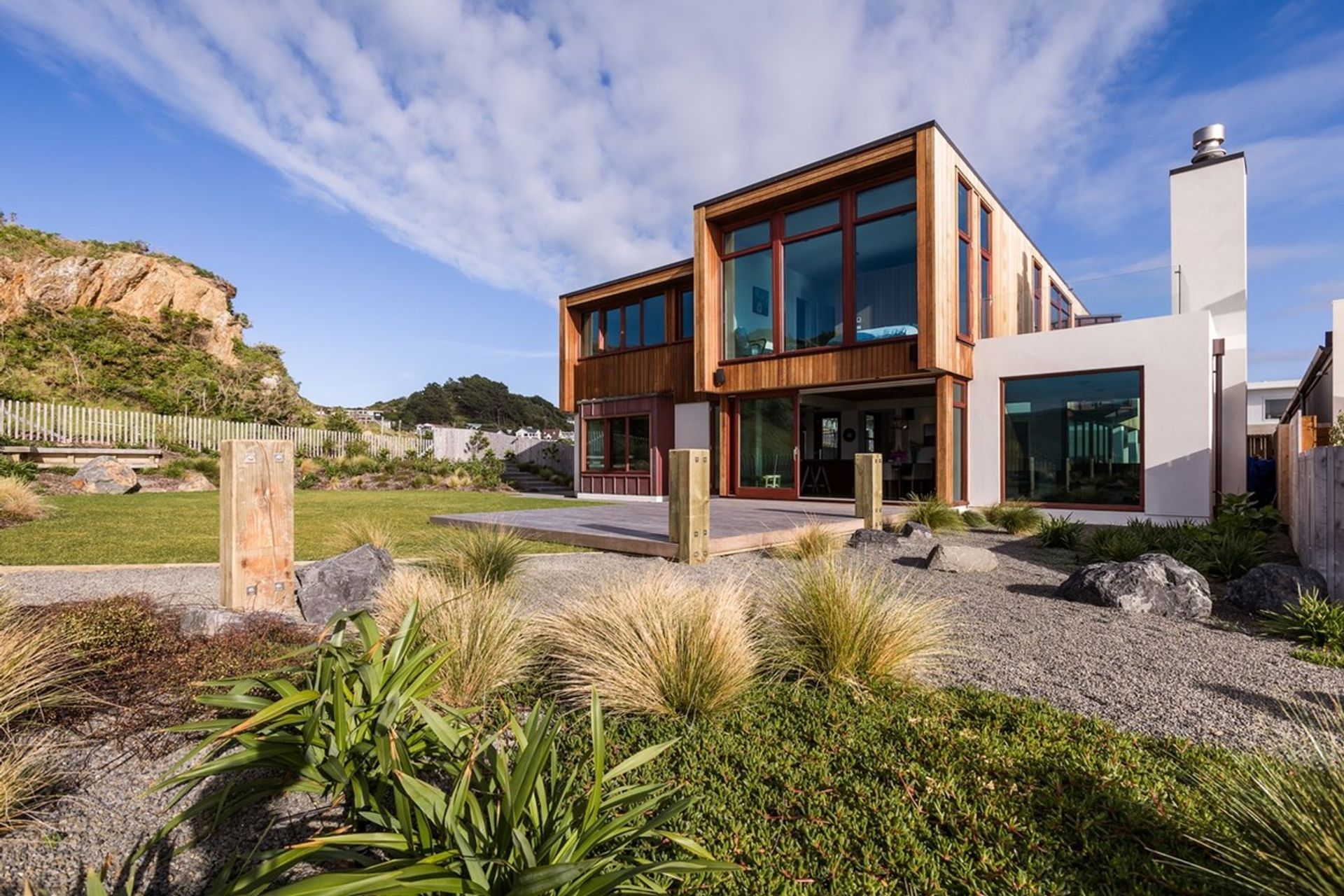 Textural materials complement the rugged landscape of this Seatoun home
