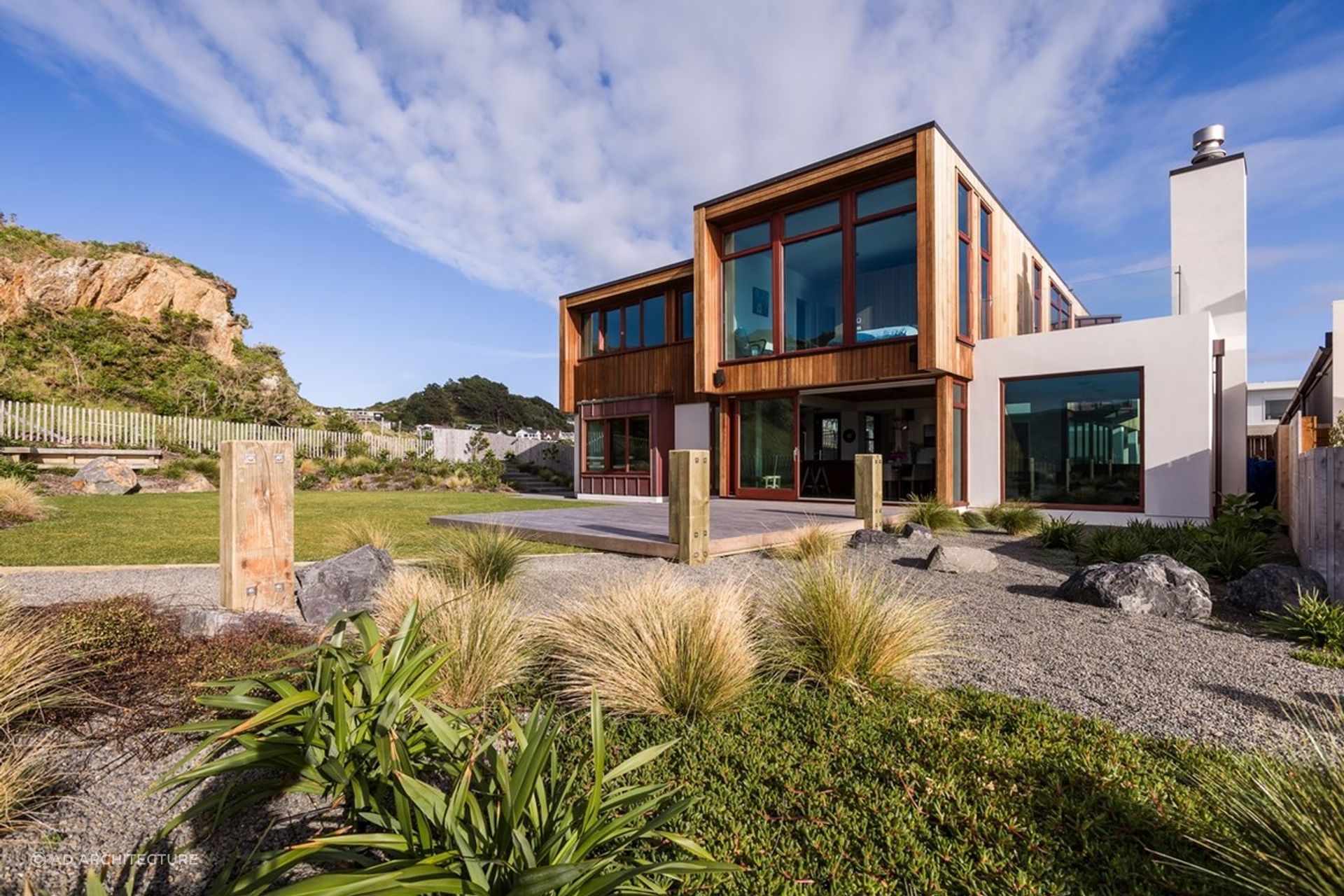 Textural materials complement the rugged landscape of this Seatoun home