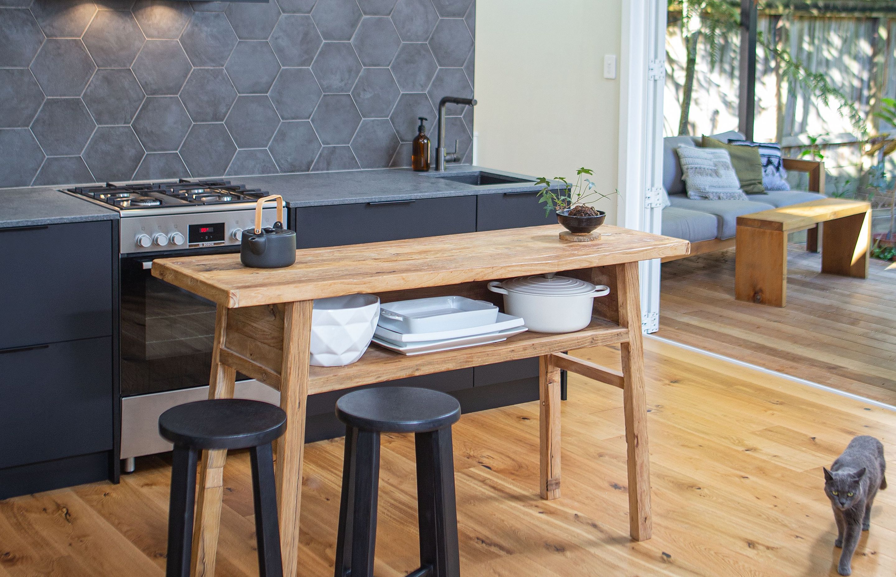 The kitchen is the heart of the home, where all other spaces converge, and where everyone comes together, including the cat.               Design: Hello Home Interiors. Photo credit: Jeff McEwan - Capture Studios.