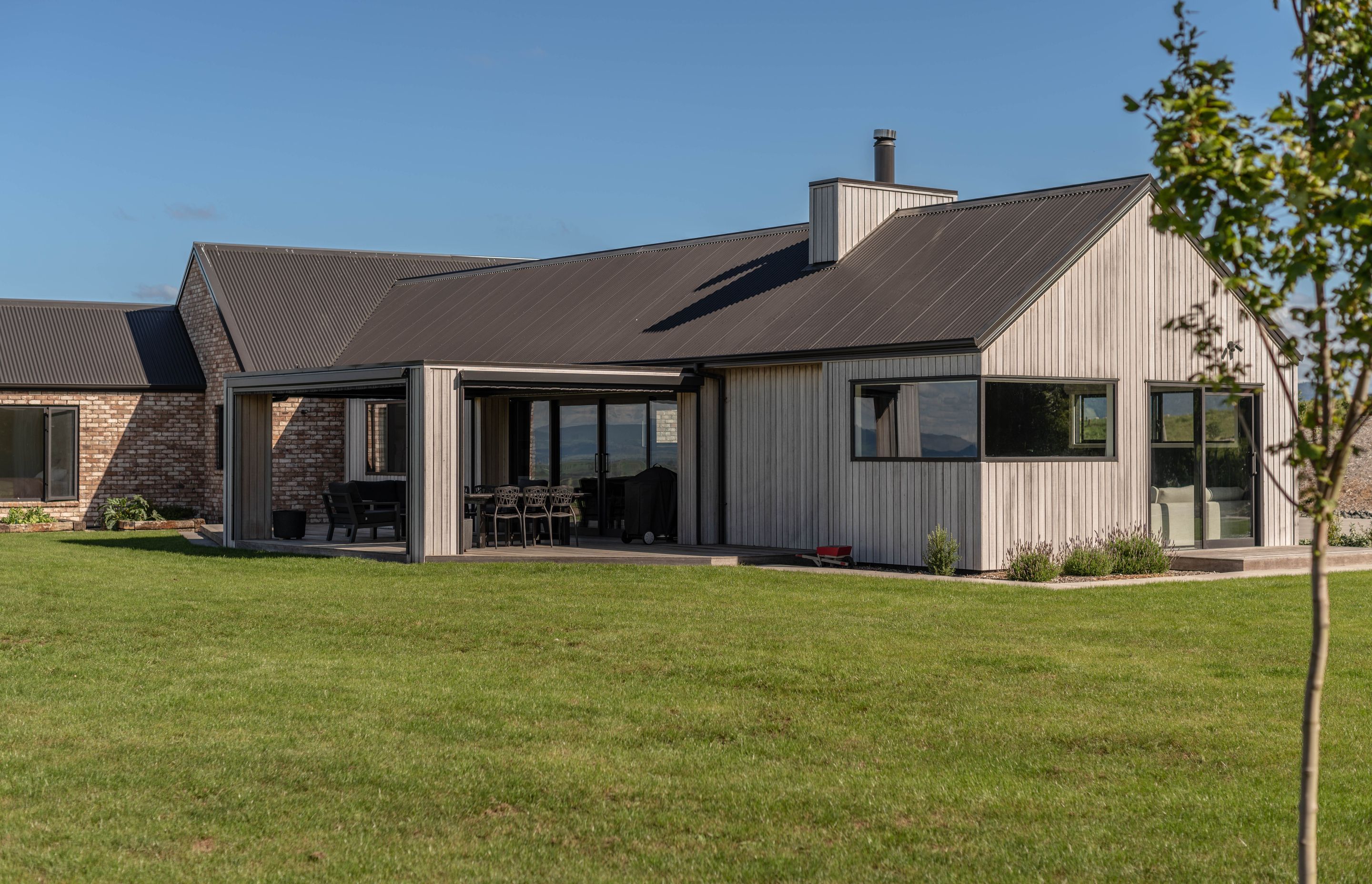 This sprawling brick and abodo-clad home is perched in the hills overlooking Hobbiton.