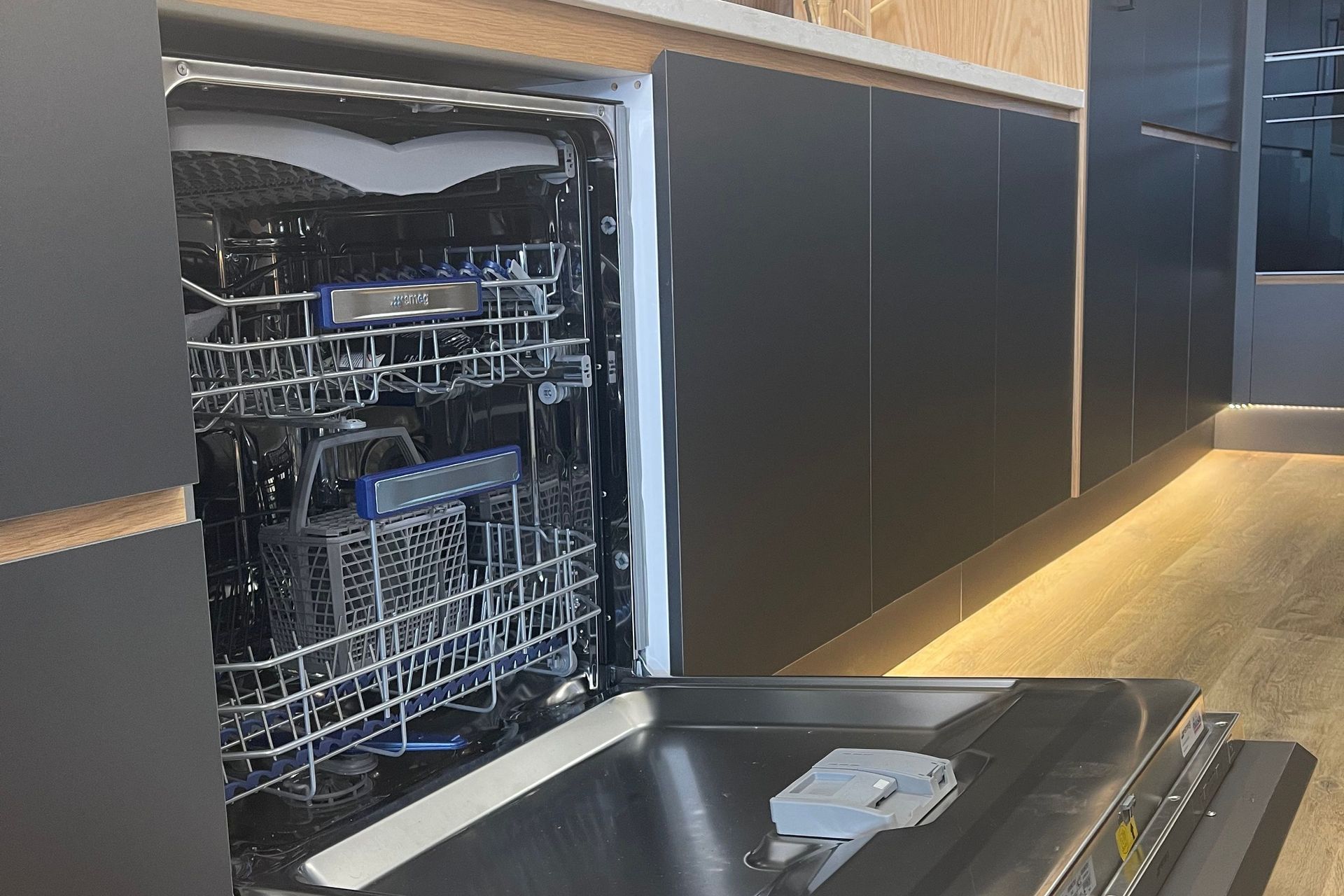 Hidden SMEG dishwasher with cabinet front attached to the exterior of the dishwasher in our kitchen showroom in Auckland