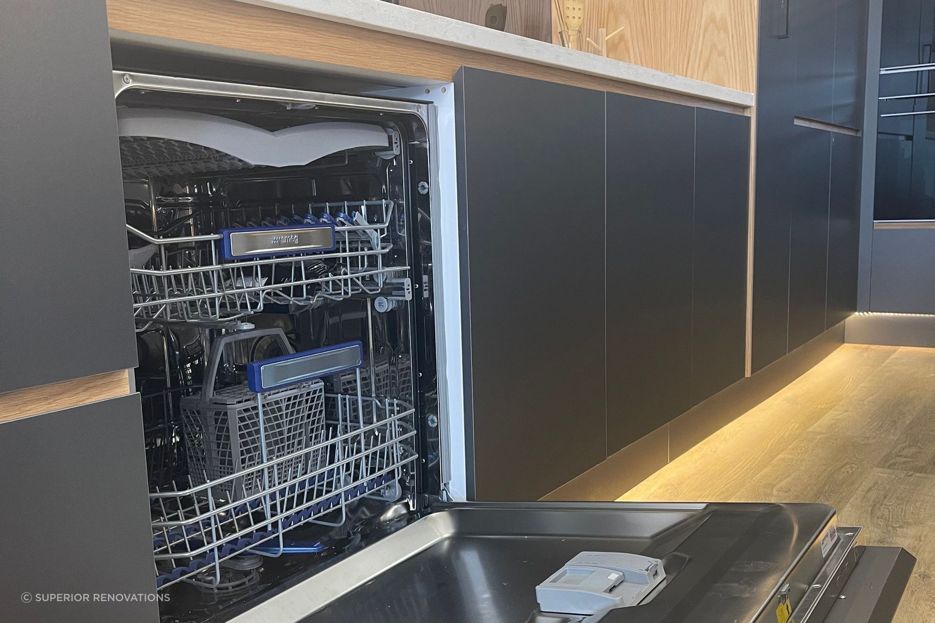 Hidden SMEG dishwasher with cabinet front attached to the exterior of the dishwasher in our kitchen showroom in Auckland