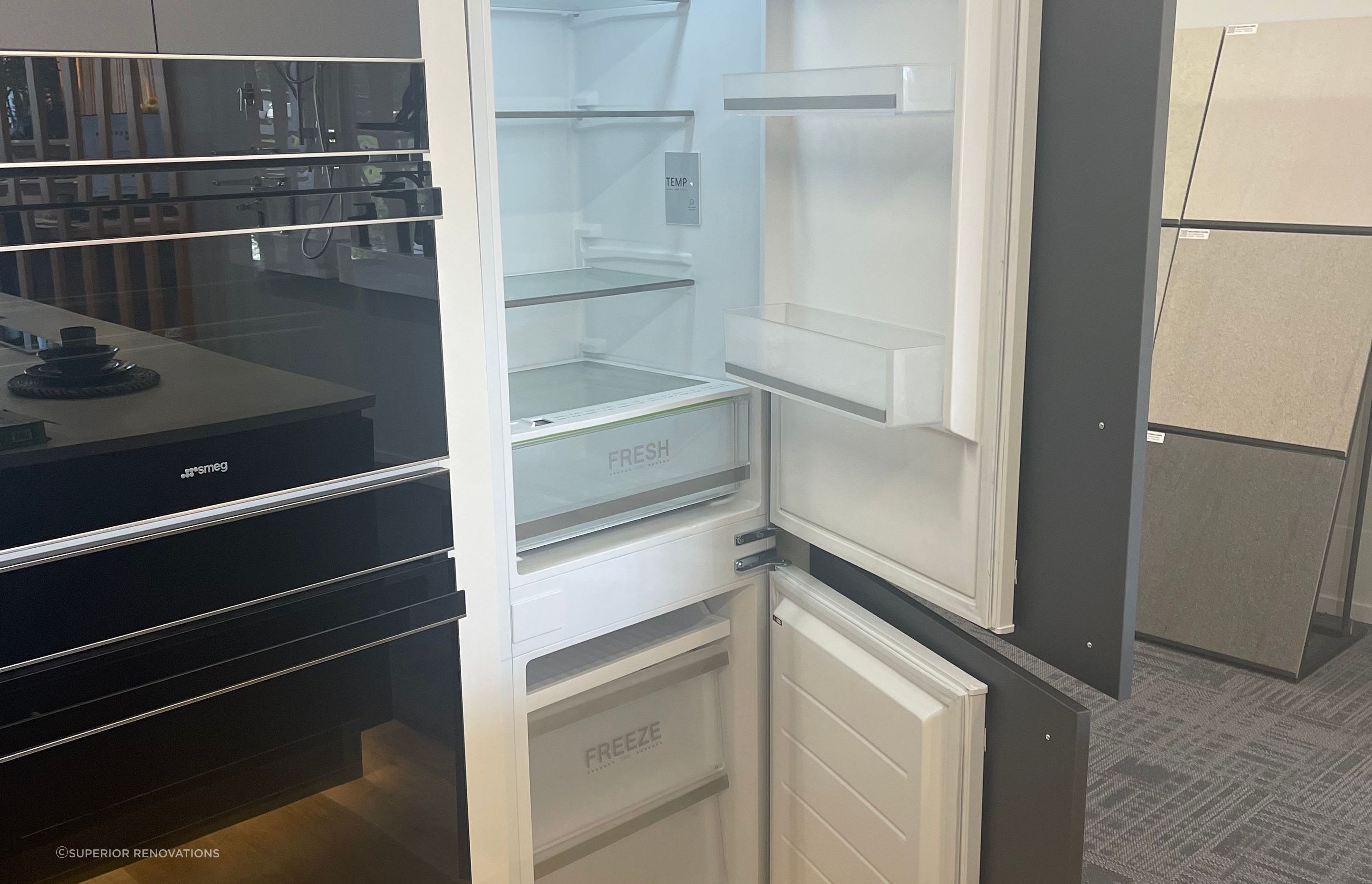 Hidden Fridge and Freezer with cabinet fronts attached to the exterior of the fridge in our Kitchen showroom in Auckland