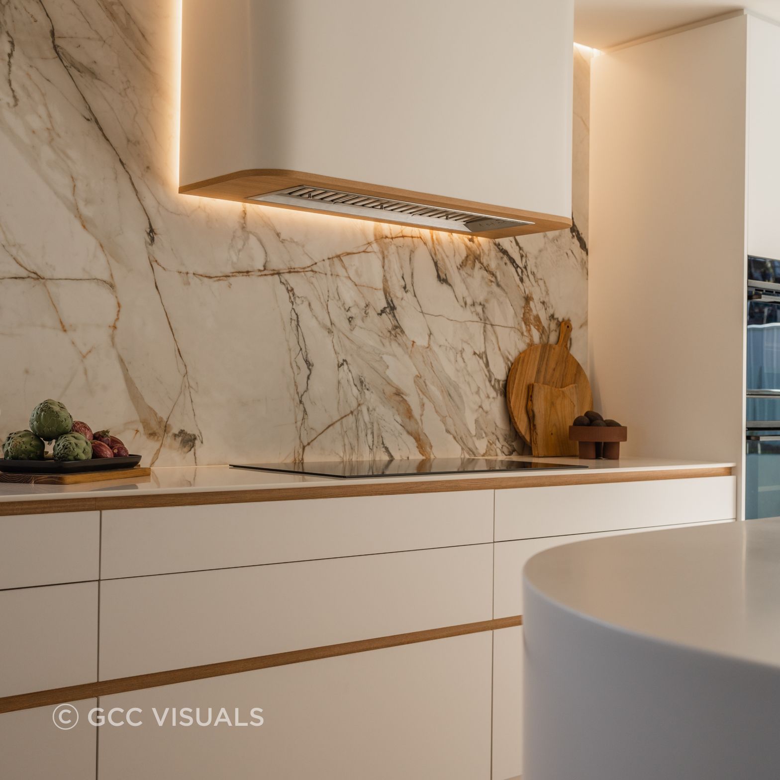 The Avenue.  Curved feature rangehood and Neolith Calcatta Luxe splashback are a feature of this coastal kitchen design
