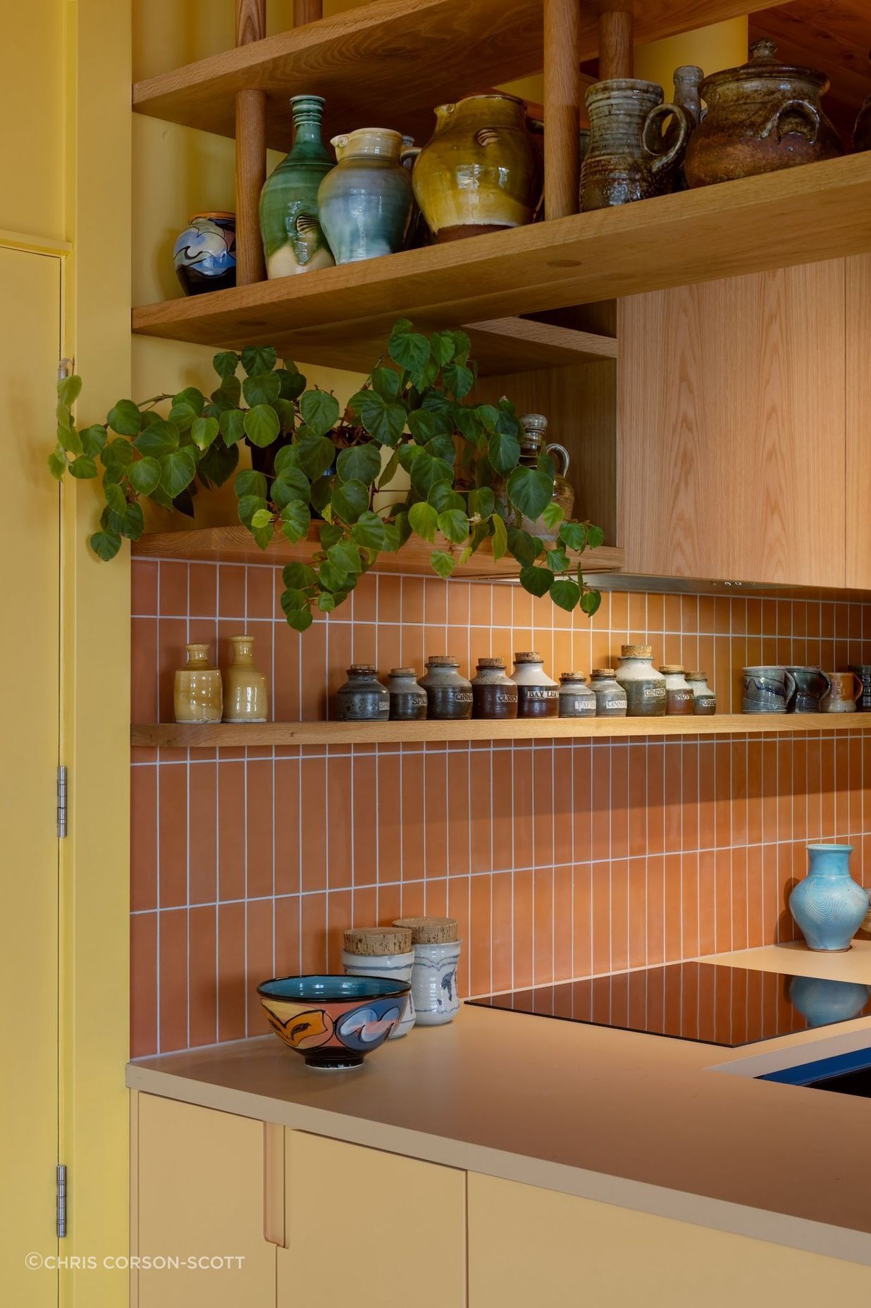 Interior Design and Architecture by Chris Corson-Scott and Pac Studio Oak shelving detail and custom cabinetry paired with the artist's collection of handmade kitchen pottery objects and vessels including pieces by Andrew Van Der Putten, Len Castle and Peter Lange