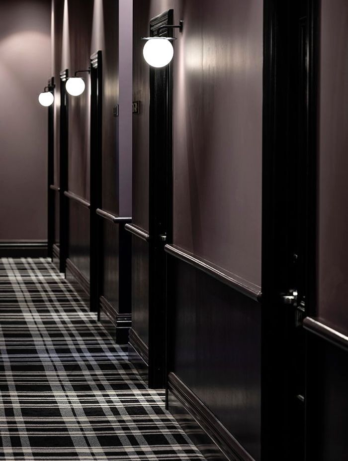 The corridors to the guest rooms. The plaid carpet is a nod to the age of the building, and references threads of the Silk Road, part of the sea captain’s literary tale.