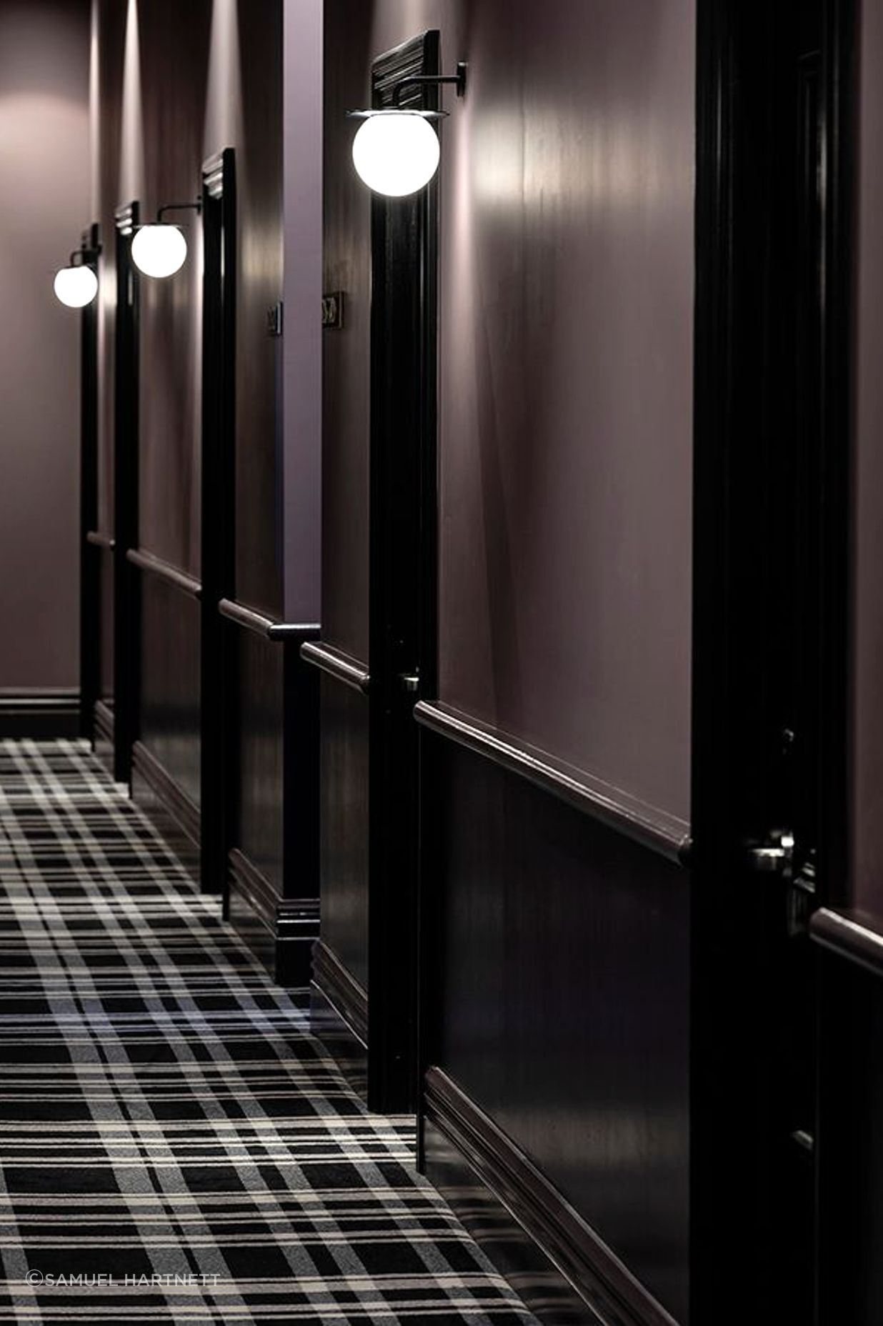 The corridors to the guest rooms. The plaid carpet is a nod to the age of the building, and references threads of the Silk Road, part of the sea captain’s literary tale.