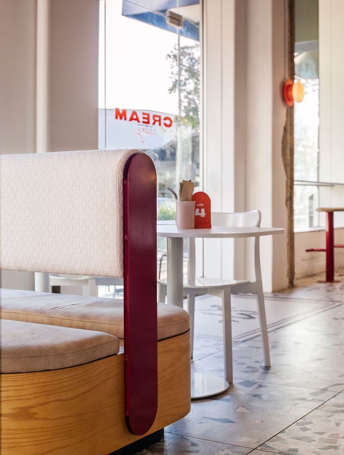 Booth seating and white tables and chairs – a call-back to the classic diner.