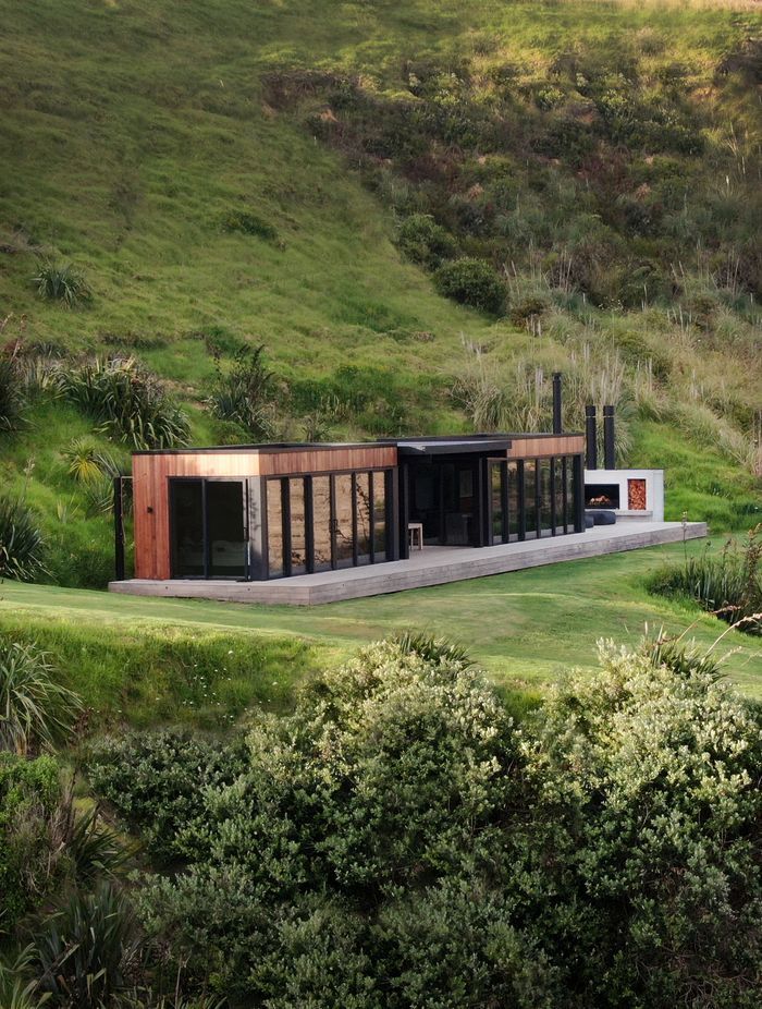 The simple home nestles into the landscape on Bridget's family farm on the Cavalli Coast.