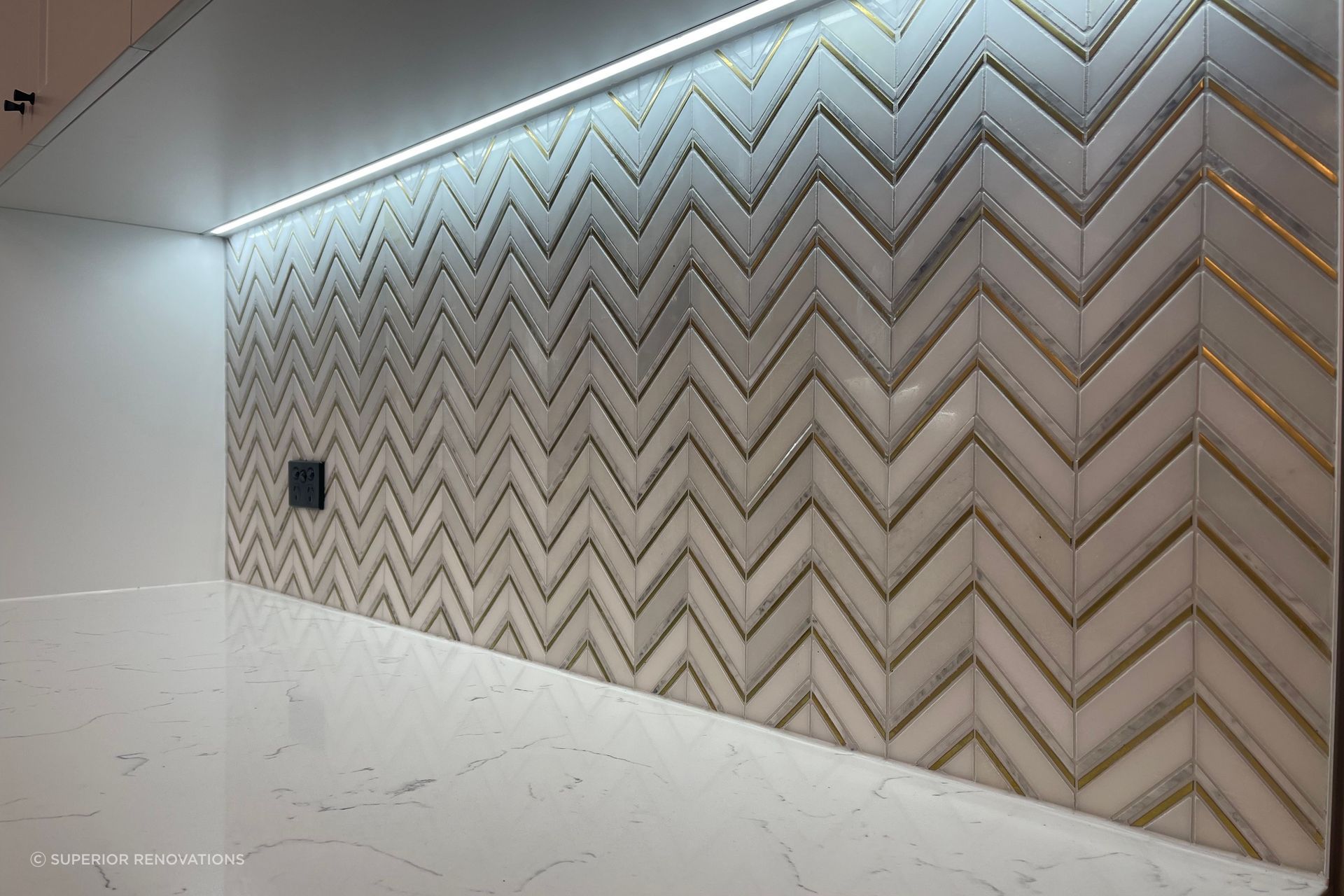 LED lights installed below the cabinets light up the feature wall which draws your eye to the wall.