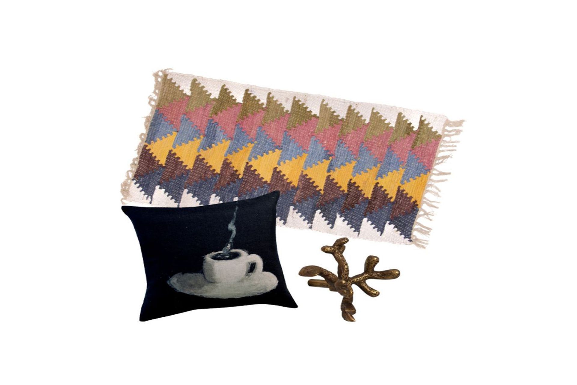 Cotton chindi rug, $59.99, from Trade Aid; Maison Levy Cafe Creme cushion, $259, from Madder & Rouge; Brass drawer knob coral floret, $17.90, from Folklore Store