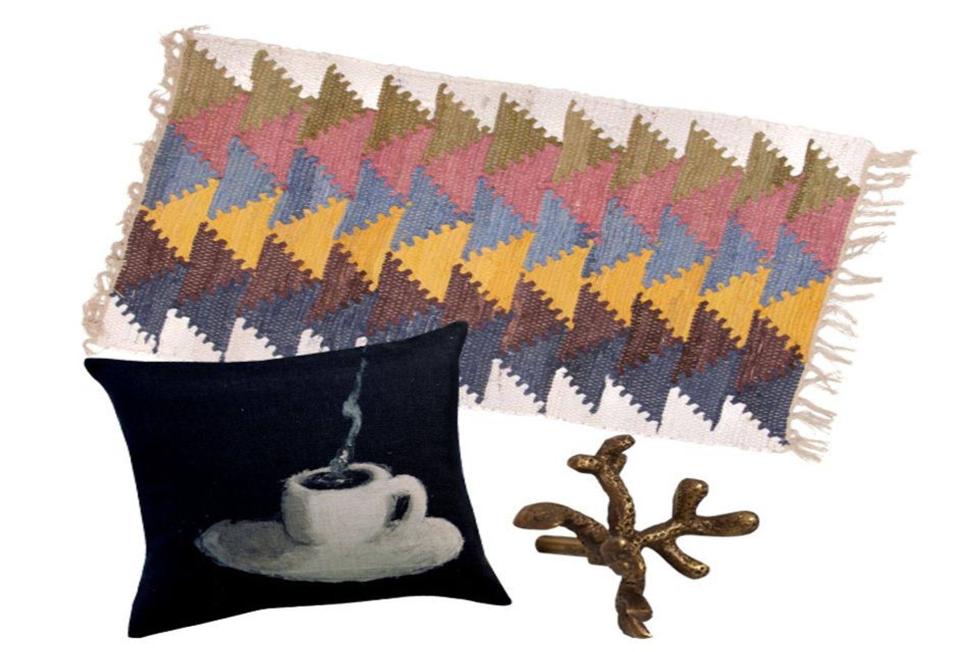 Cotton chindi rug, $59.99, from Trade Aid; Maison Levy Cafe Creme cushion, $259, from Madder &amp; Rouge; Brass drawer knob coral floret, $17.90, from Folklore Store