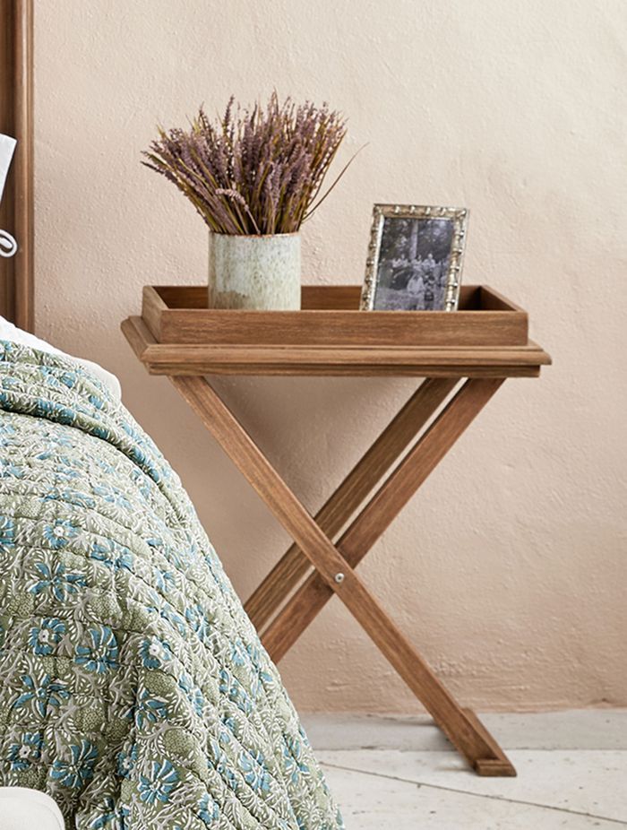 Exuding rustic charm and earthy tones, the cross leg tray table stands as a unique blend of functionality and style.