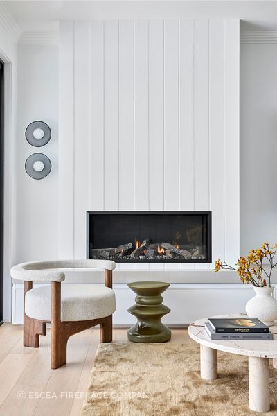 Escea’s Zero Clearance rating allows non-combustible materials to be used around the fire — enabling the fire to be wrapped in panelled white timber, seamlessly blending it into the relaxed textures and coastal tones of the family zone.