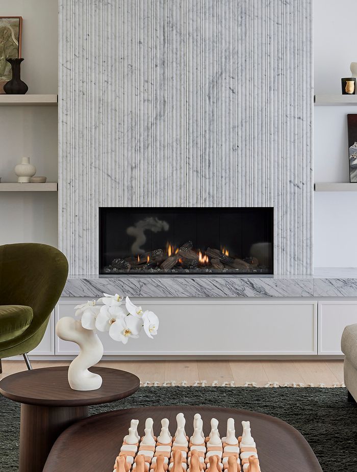 With its sleek, frameless design and advanced Zero Clearance rating, the Escea DS1150 offered complete freedom to execute the vision — seamlessly integrating the fireplace into the stone and marble surround, with custom shaker cabinetry installed directly below.