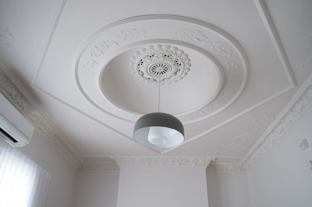 The beautifully detailed ceiling was restored with careful attention from the painter.