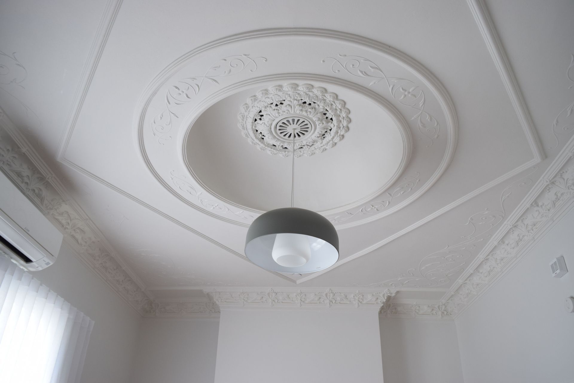 The beautifully detailed ceiling was restored with careful attention from the painter.