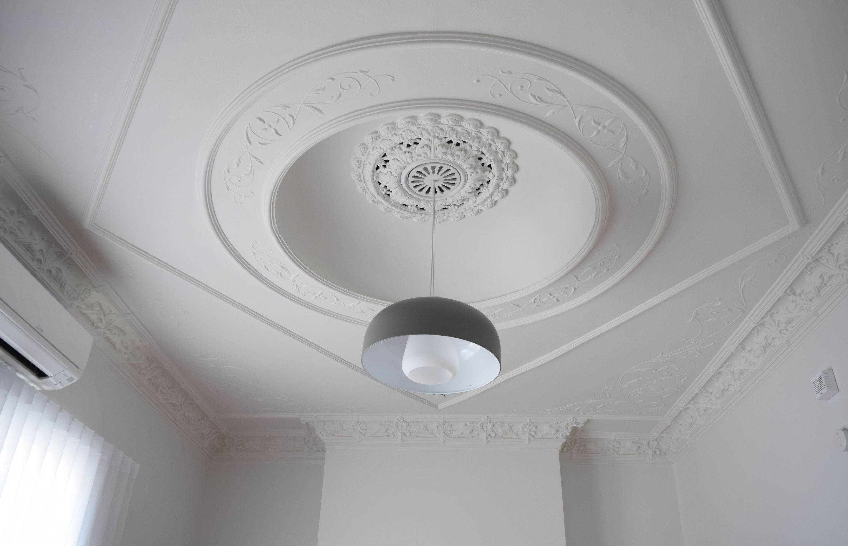 The beautifully detailed ceiling was restored with careful attention from the painter.