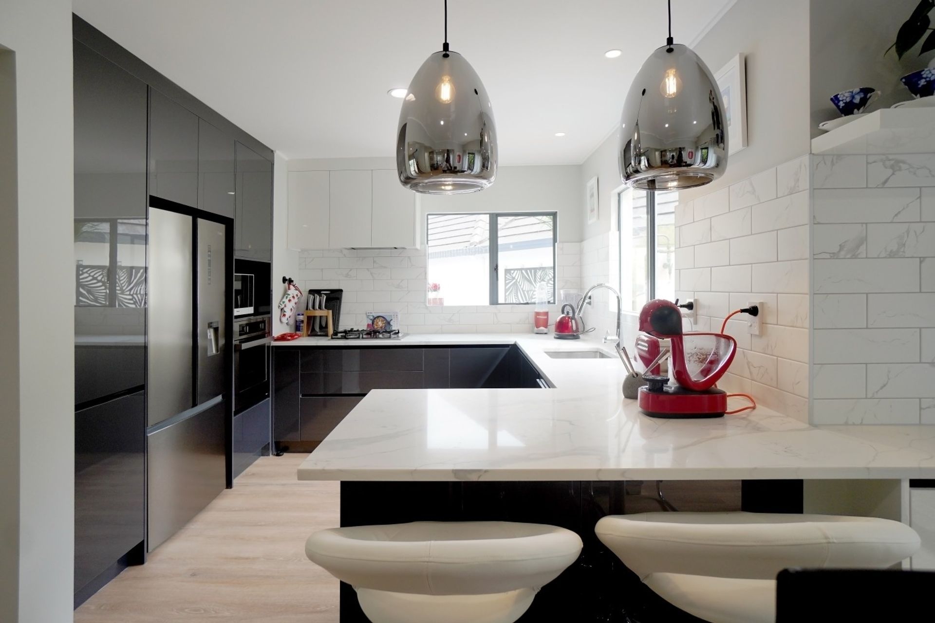 Simple modern Kitchen renovation uses decorative lighting within the kitchen design. See full video transformation below.