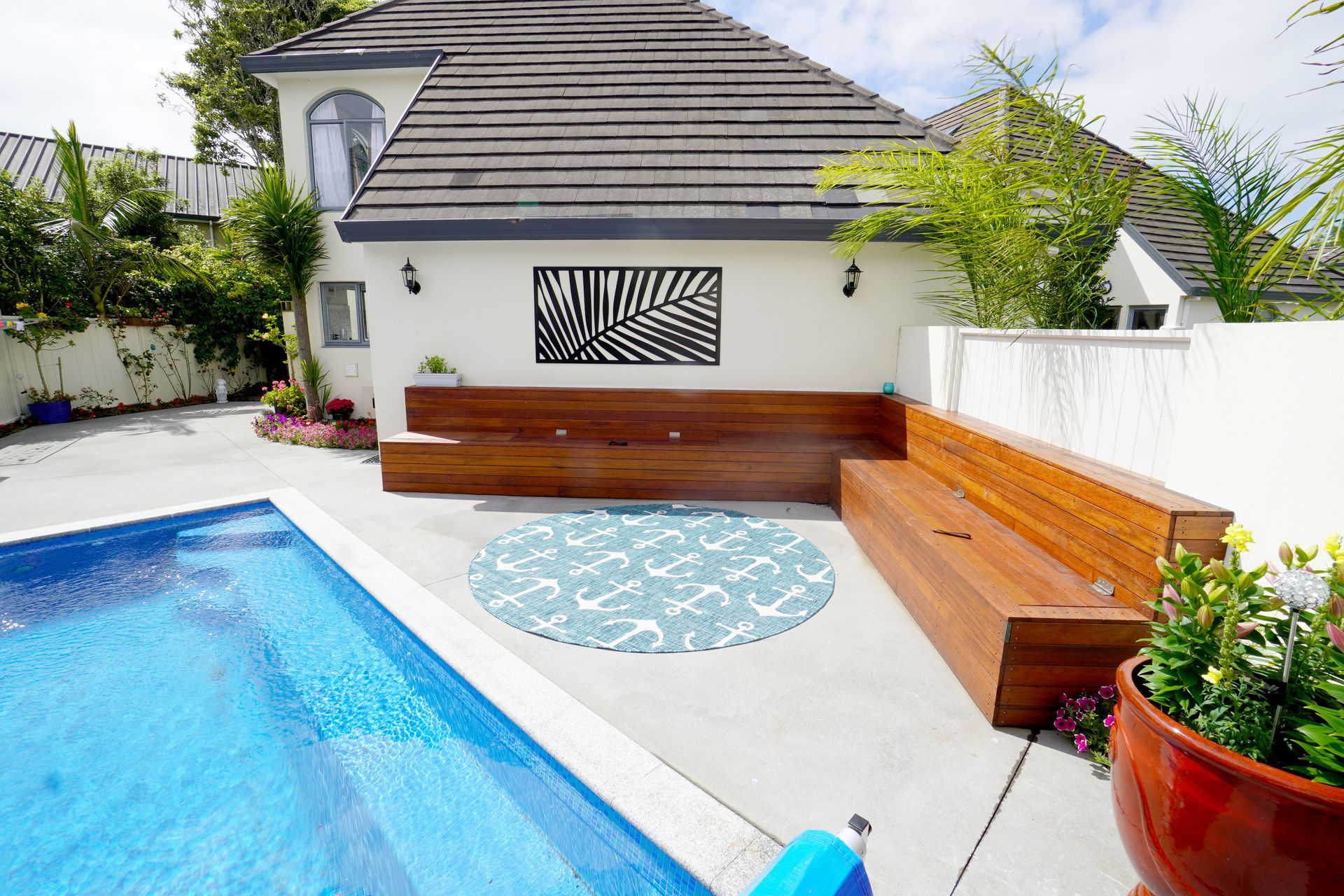 This outdoor landscaping was done as a part of an interior renovation in Epsom, Auckland. Our client loved to entertain her friends and wanted an attractive and welcoming space outdoors where they could relax. We custom built the benches that can be seen which also has storage within it.