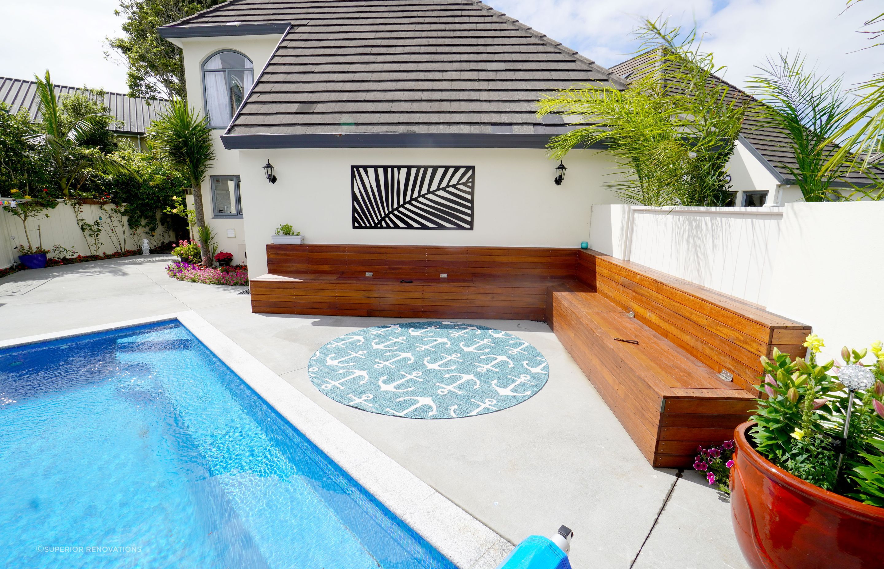 This outdoor landscaping was done as a part of an interior renovation in Epsom, Auckland. Our client loved to entertain her friends and wanted an attractive and welcoming space outdoors where they could relax. We custom built the benches that can be seen which also has storage within it.