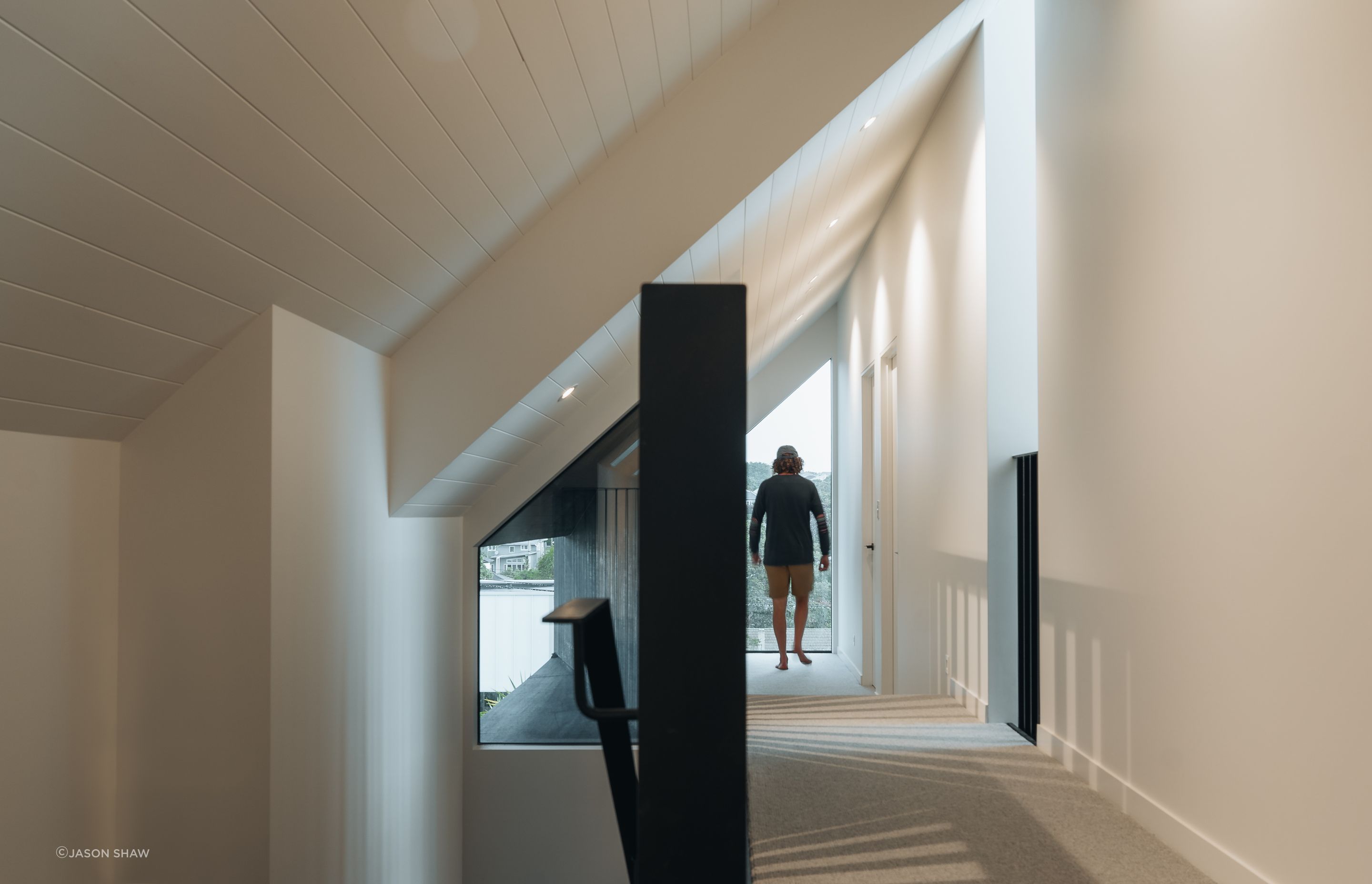The top storey of the home makes the most of available space with the hallway tucked into the slant of the gabled roof.