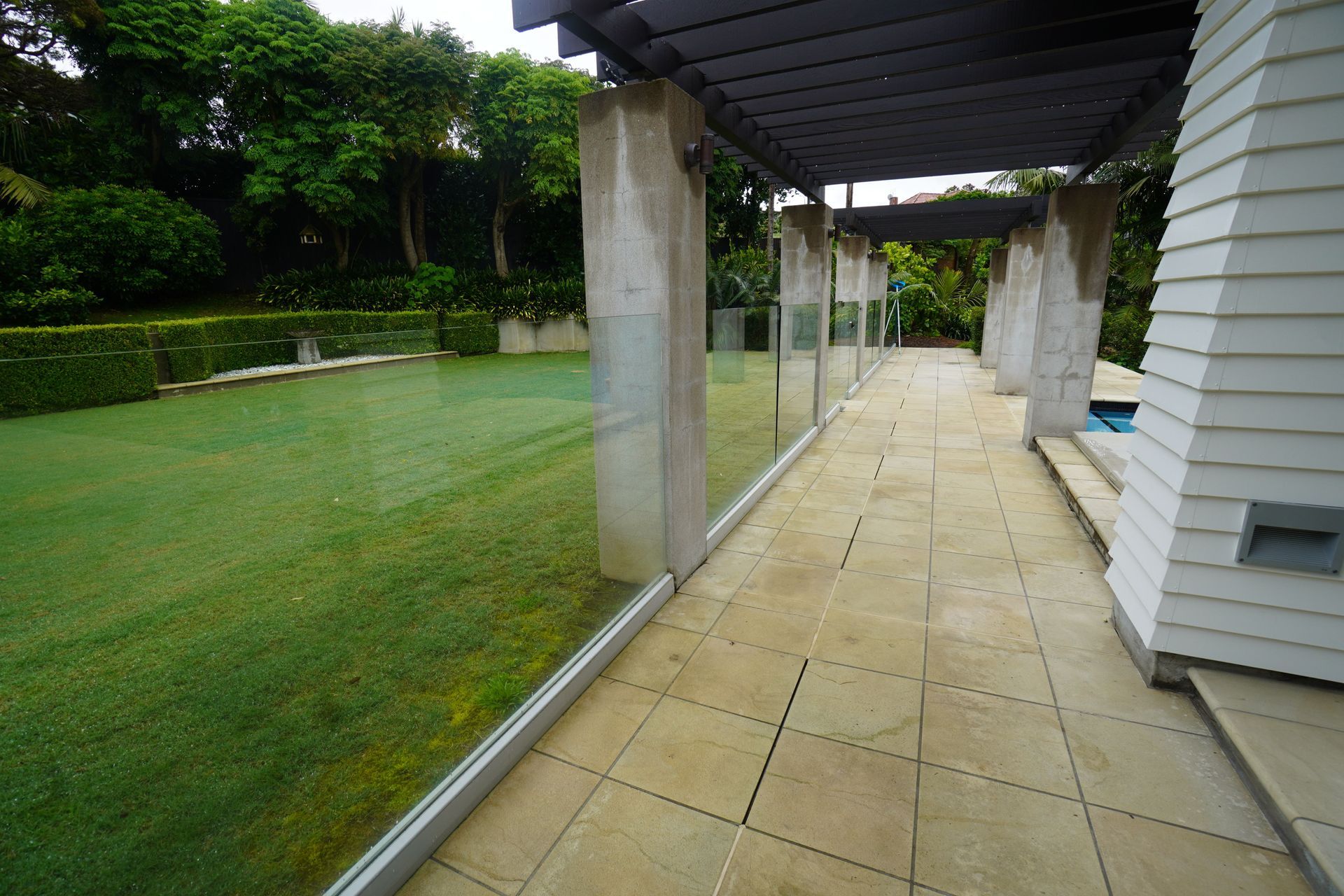 The glass fences are used to divide the different living spaces of the landscape with a different purpose for each area.