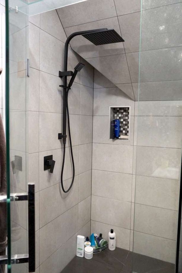 Bathroom renovation in Cockle Bay, Auckland. A shower niche was created in the wall of the tiled shower as a design feature.