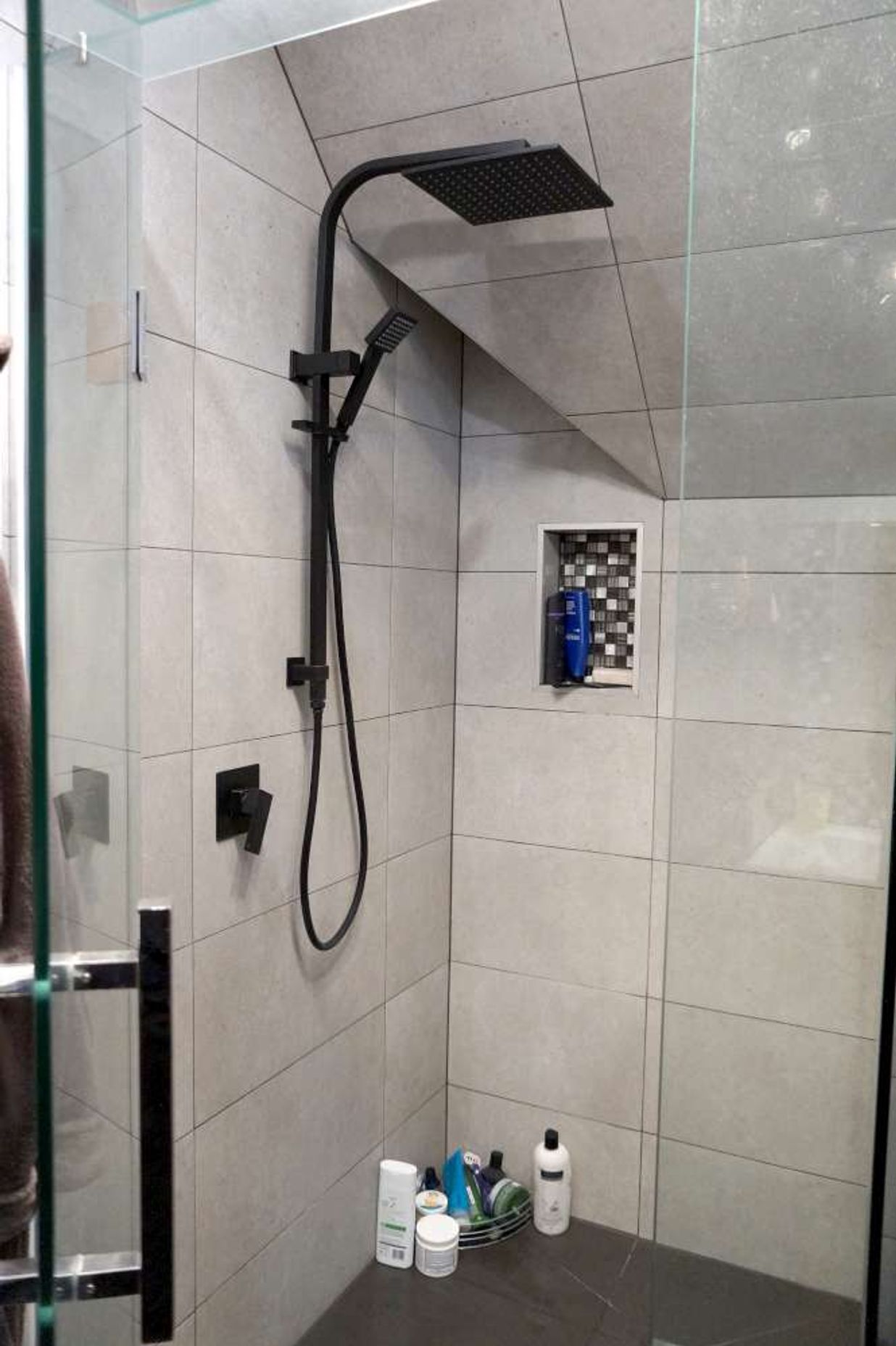 Bathroom renovation in Cockle Bay, Auckland. A shower niche was created in the wall of the tiled shower as a design feature.