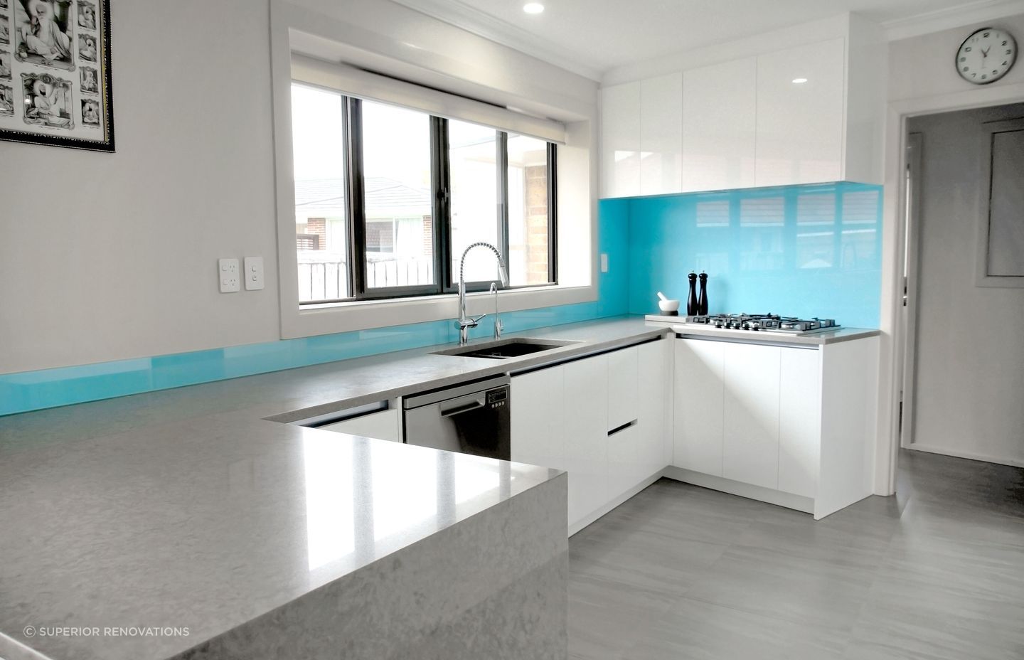 A sky blue backplash was added to add some colour into a neutral themed kitchen in Papatoetoe