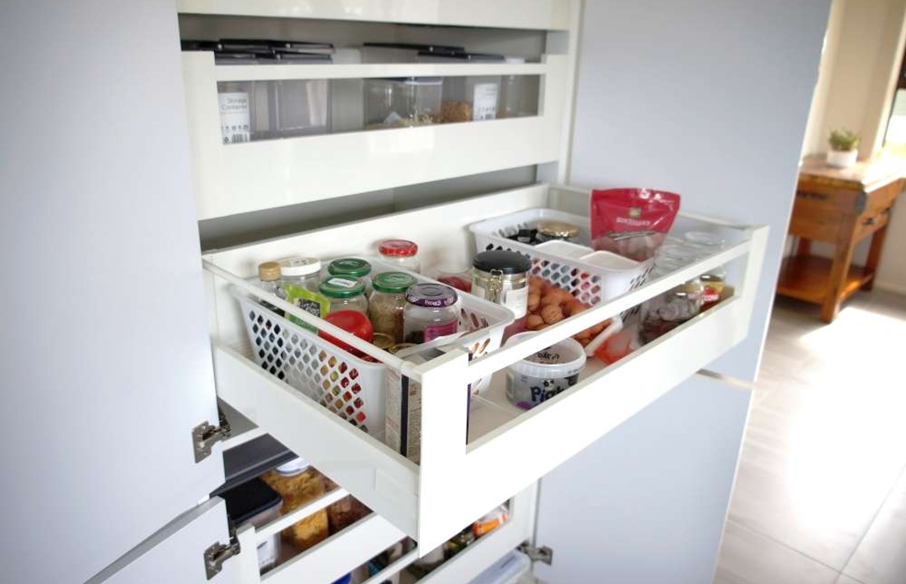 A custom built pantry with pull out drawers for better storage and organisation