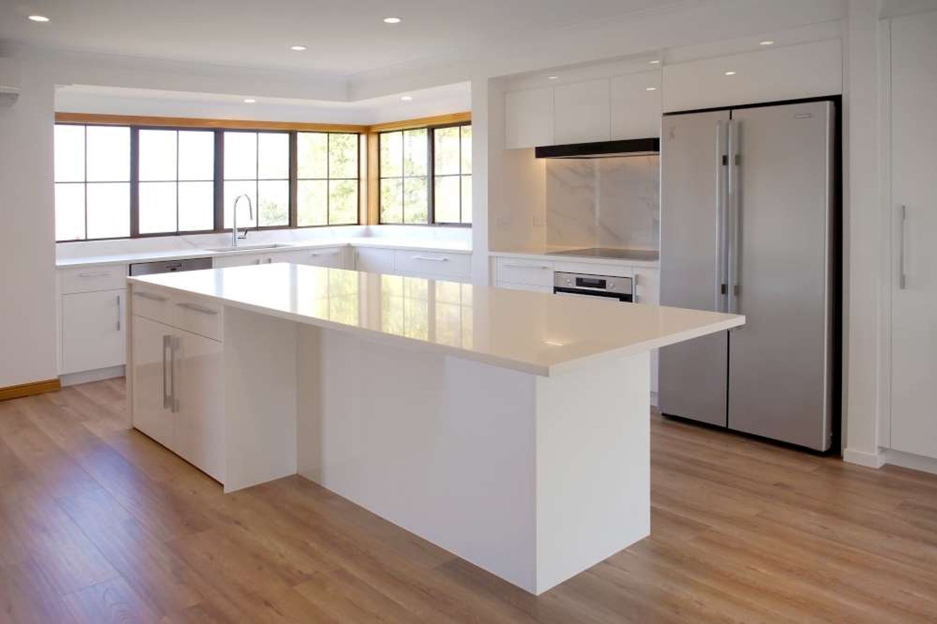 Kitchen renovation in Blockhouse Bay: Custom built large island which doubles as a storage solution with cabinets and as a breakfast and prep bar.
