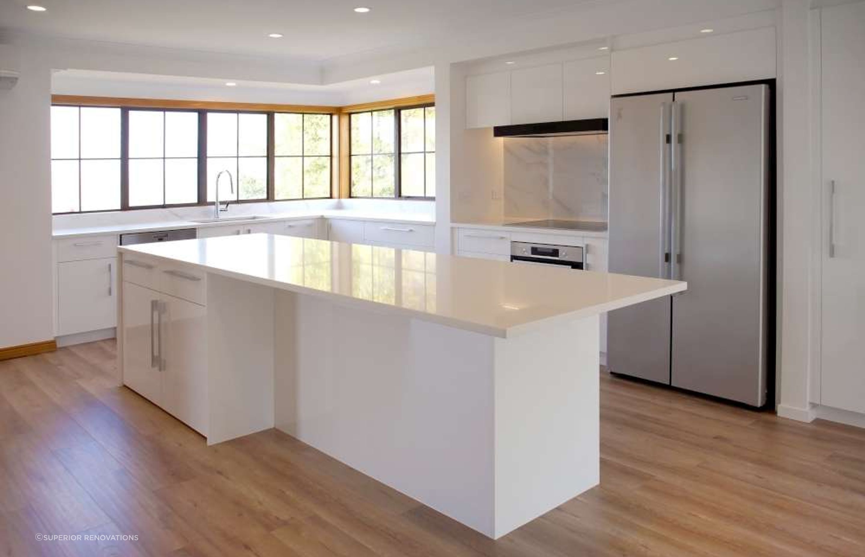 Kitchen renovation in Blockhouse Bay: Custom built large island which doubles as a storage solution with cabinets and as a breakfast and prep bar.