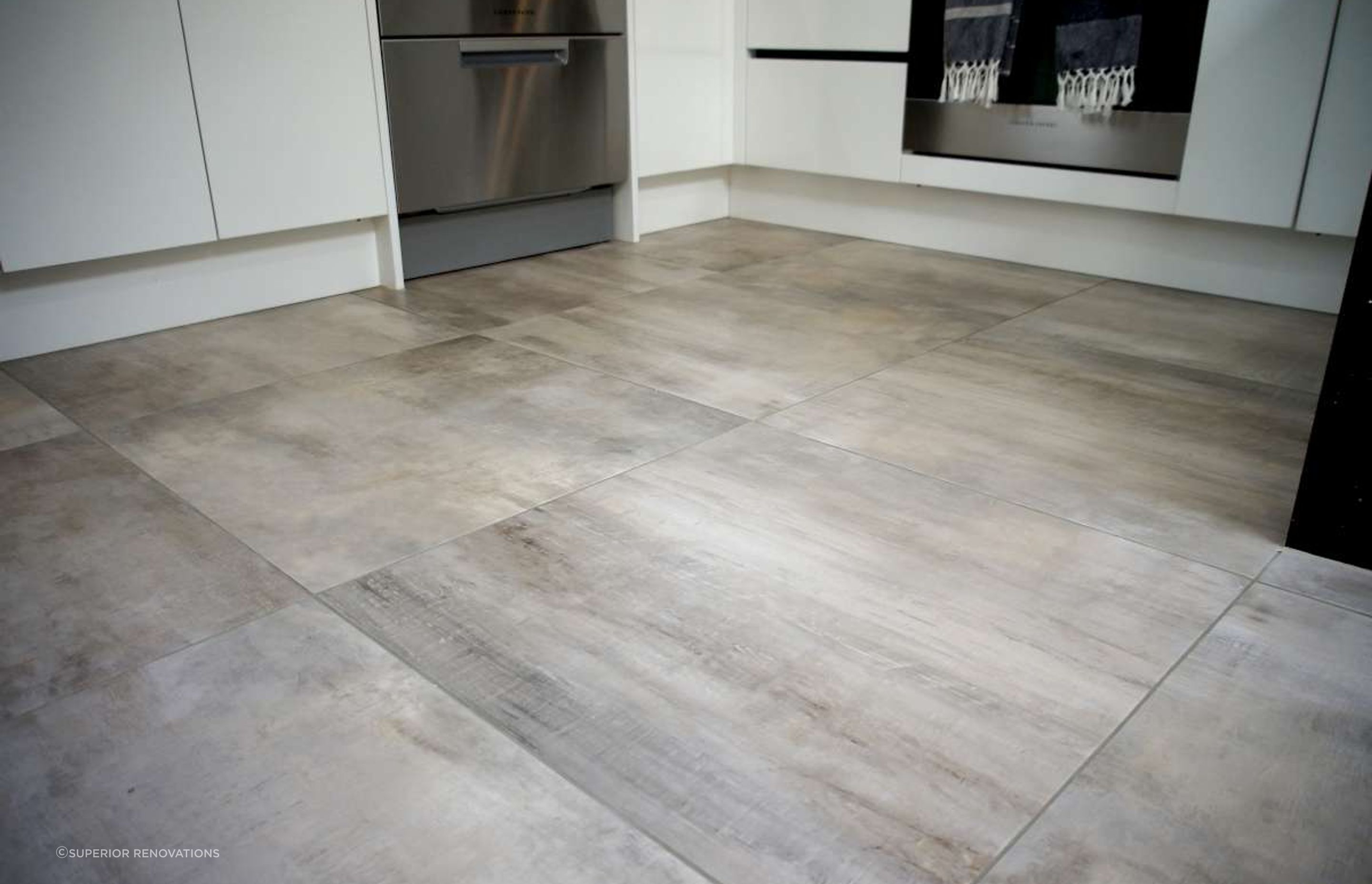 Kitchen renovation in Bucklands Beach: Ceramic tiles which mimic hardwood were installed for easy maintenance and as a cost effective option