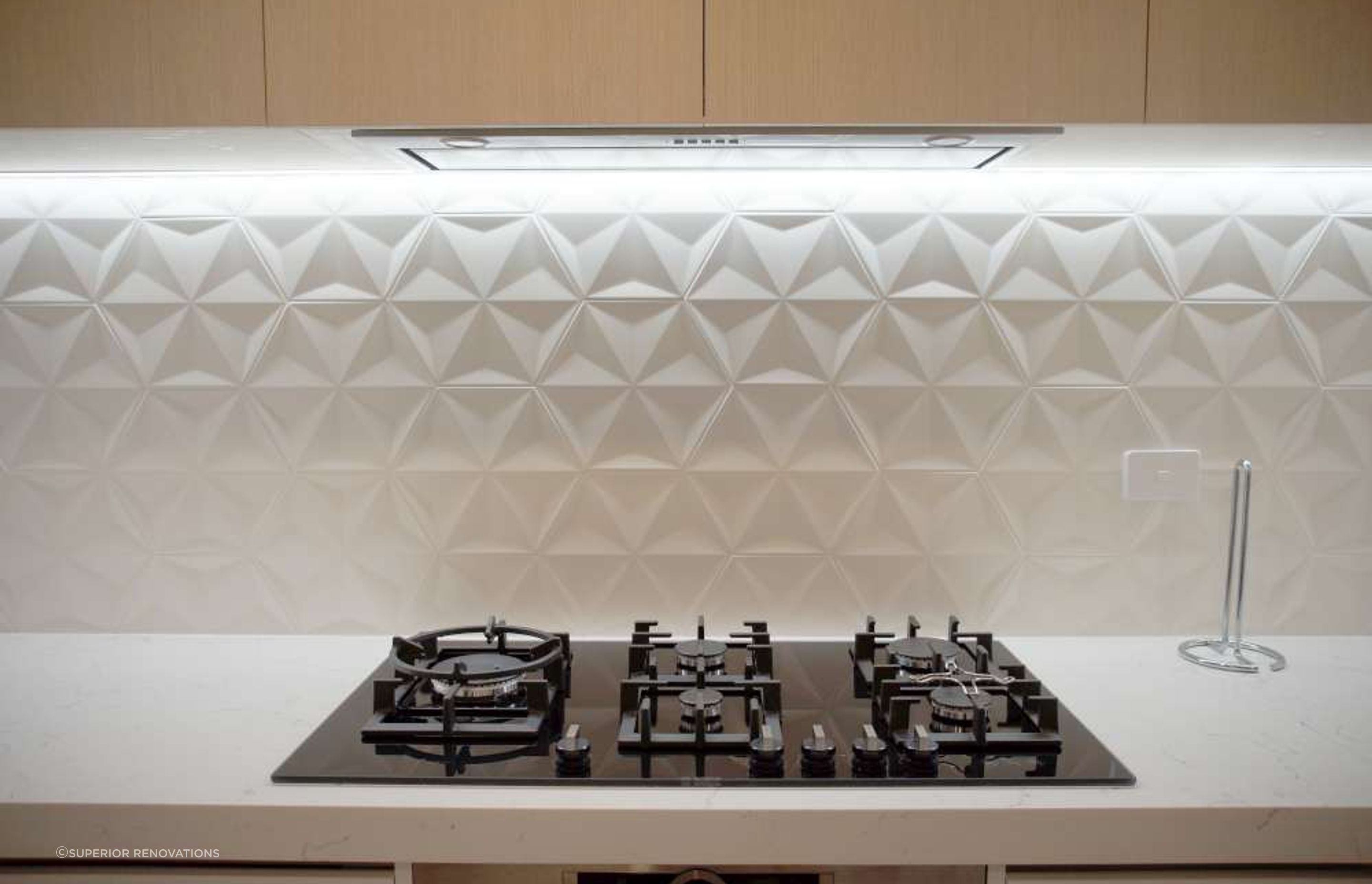 Kitchen renovation in Parnell: We added textured 3D tiles as a backsplash for this client to add character and interest in the kitchen wall.