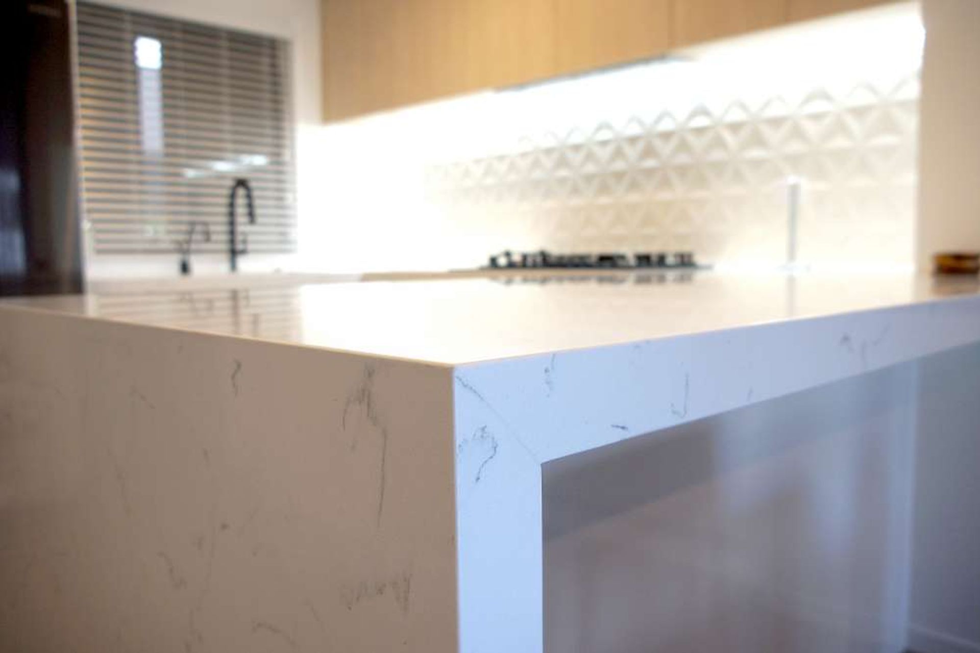 Stone engineered countertop with a matte marble look — Kitchen renovation in Parnell