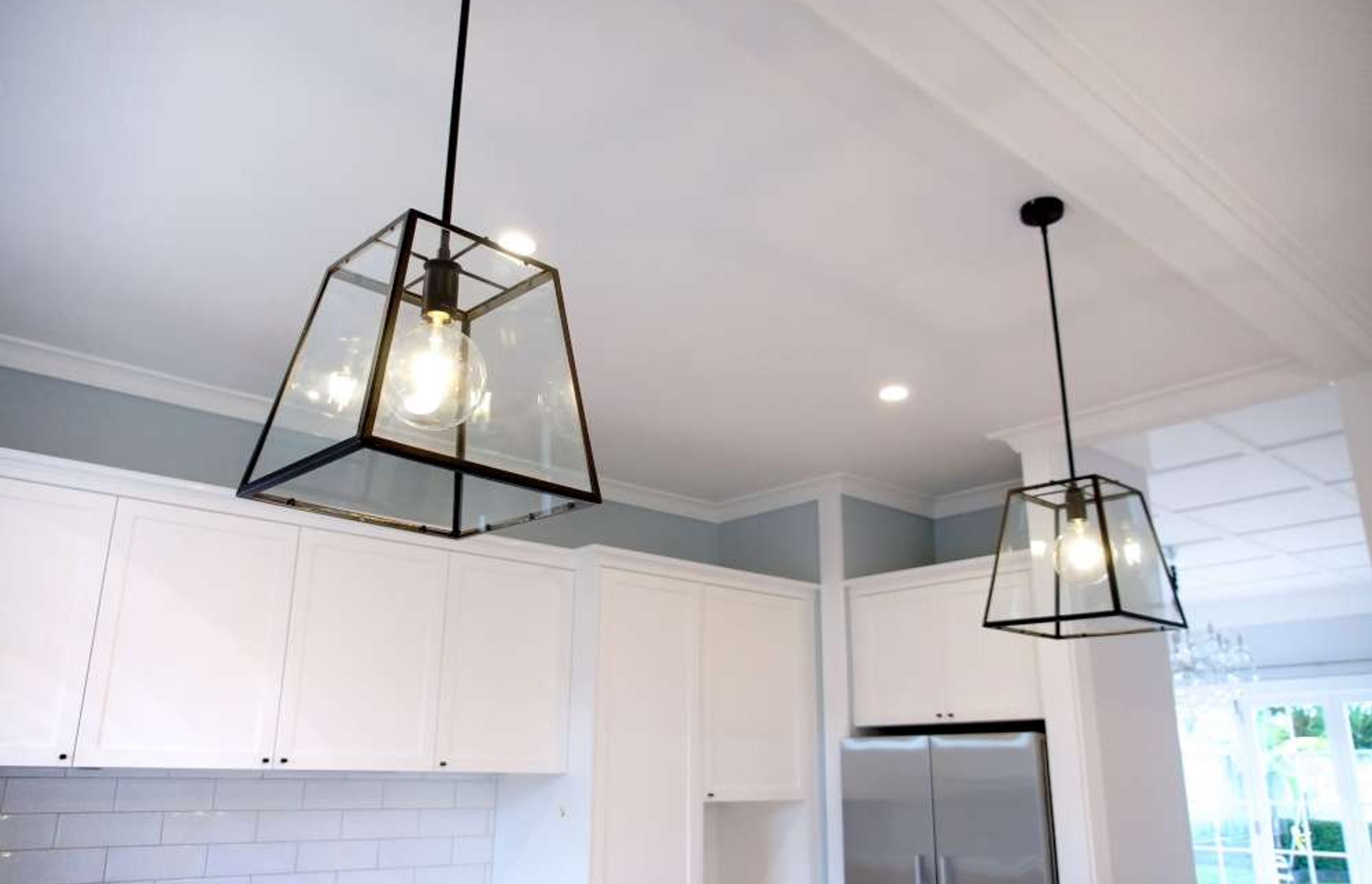 Two separate long pendant lights installed above the breakfast Island