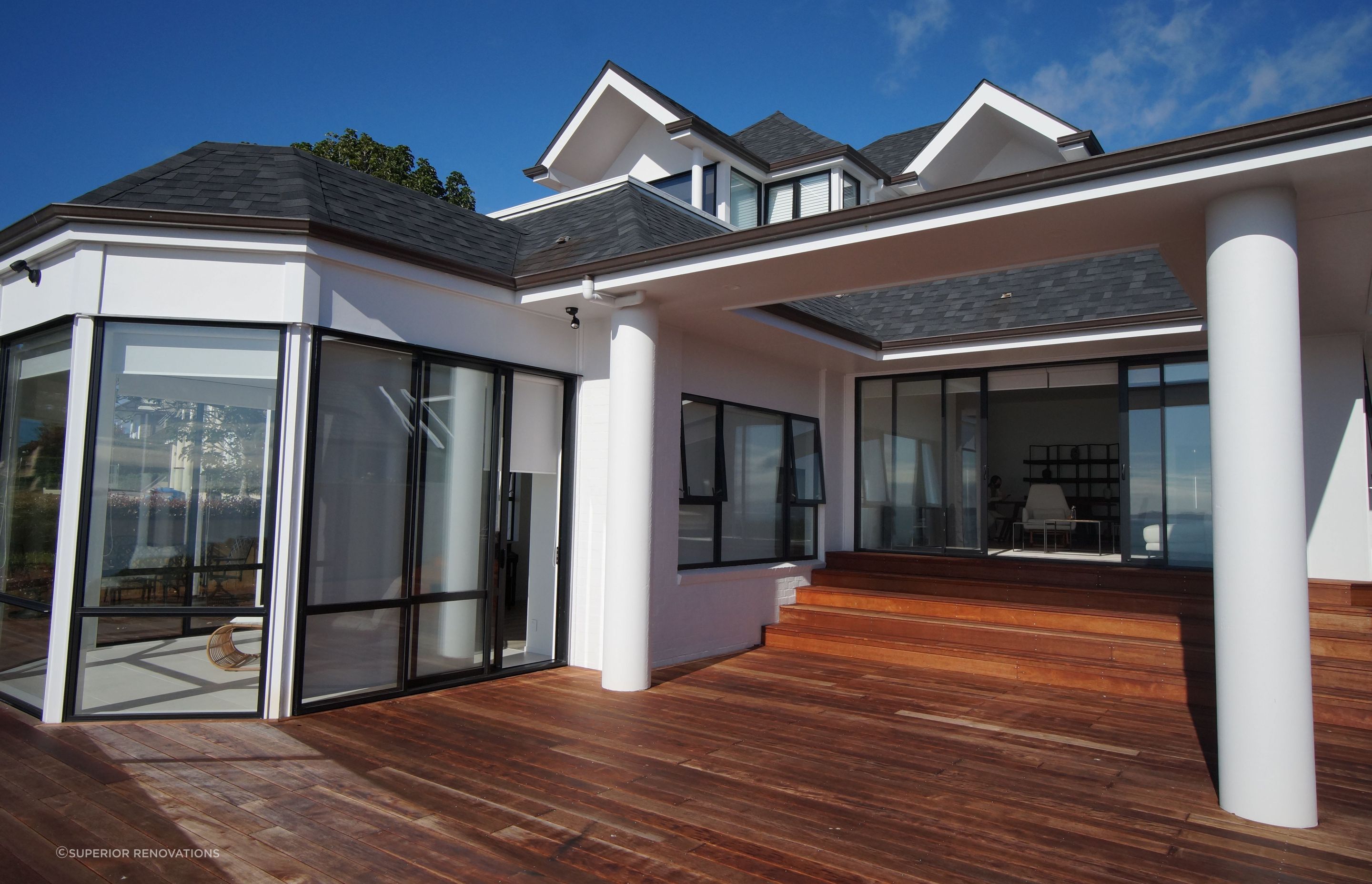 This elevation of the deck shows a beautiful Kwila Deck which contrasts beautifully with the off white walls, and columns of the house.